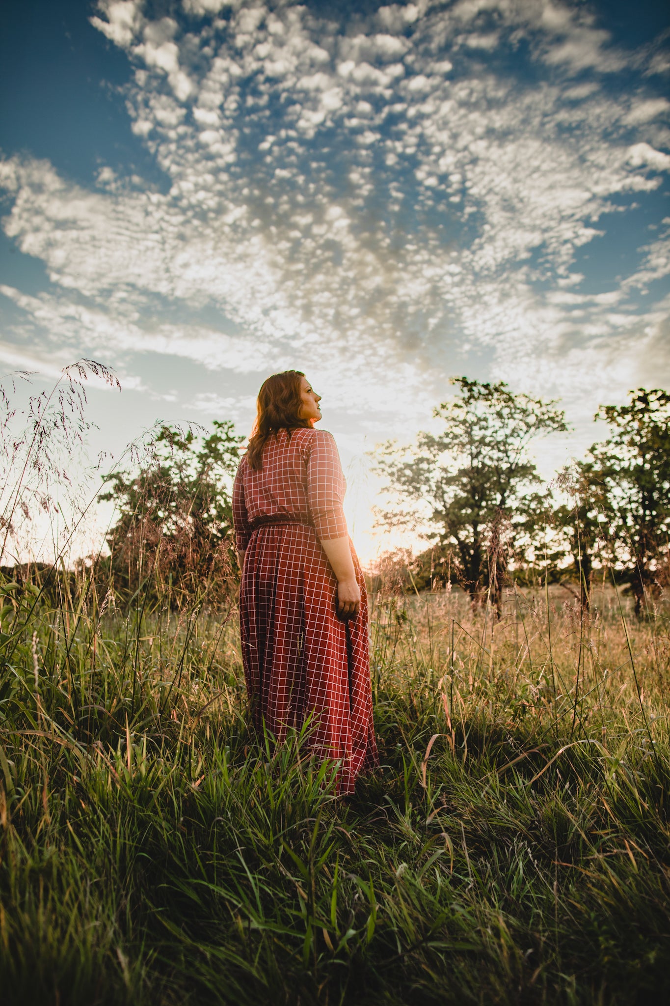 Woman in modest nursing copper windowpane dress