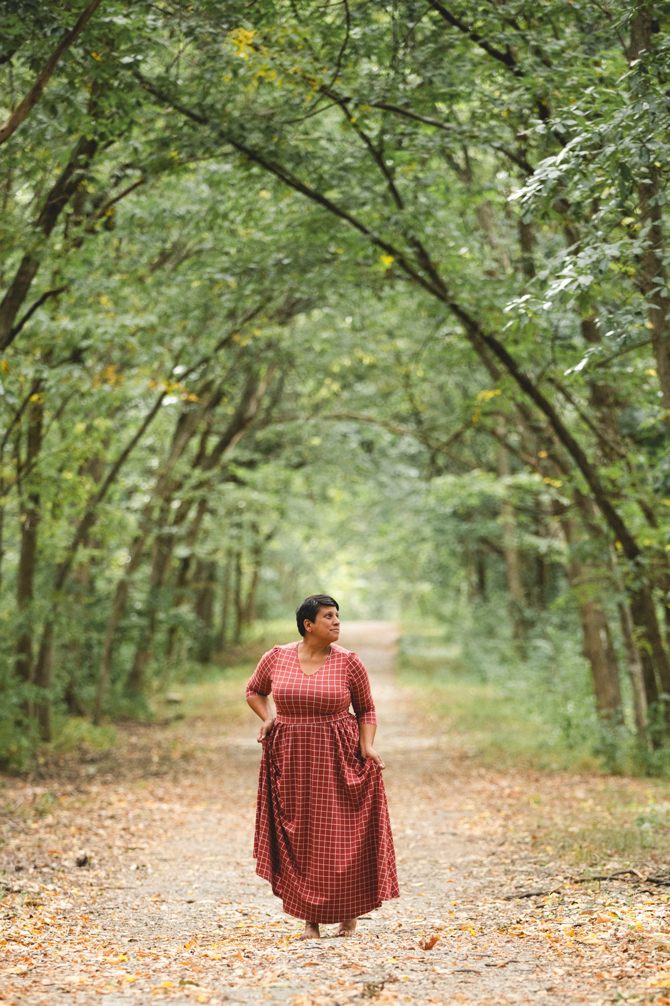 Woman in modest nursing copper windowpane maxi dress