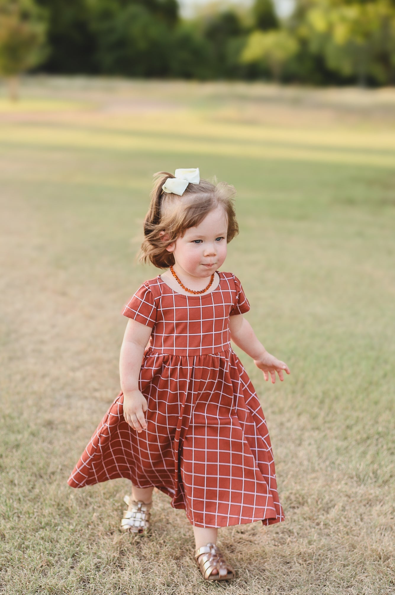 Girl in modest checkered dress, ready for nursing.