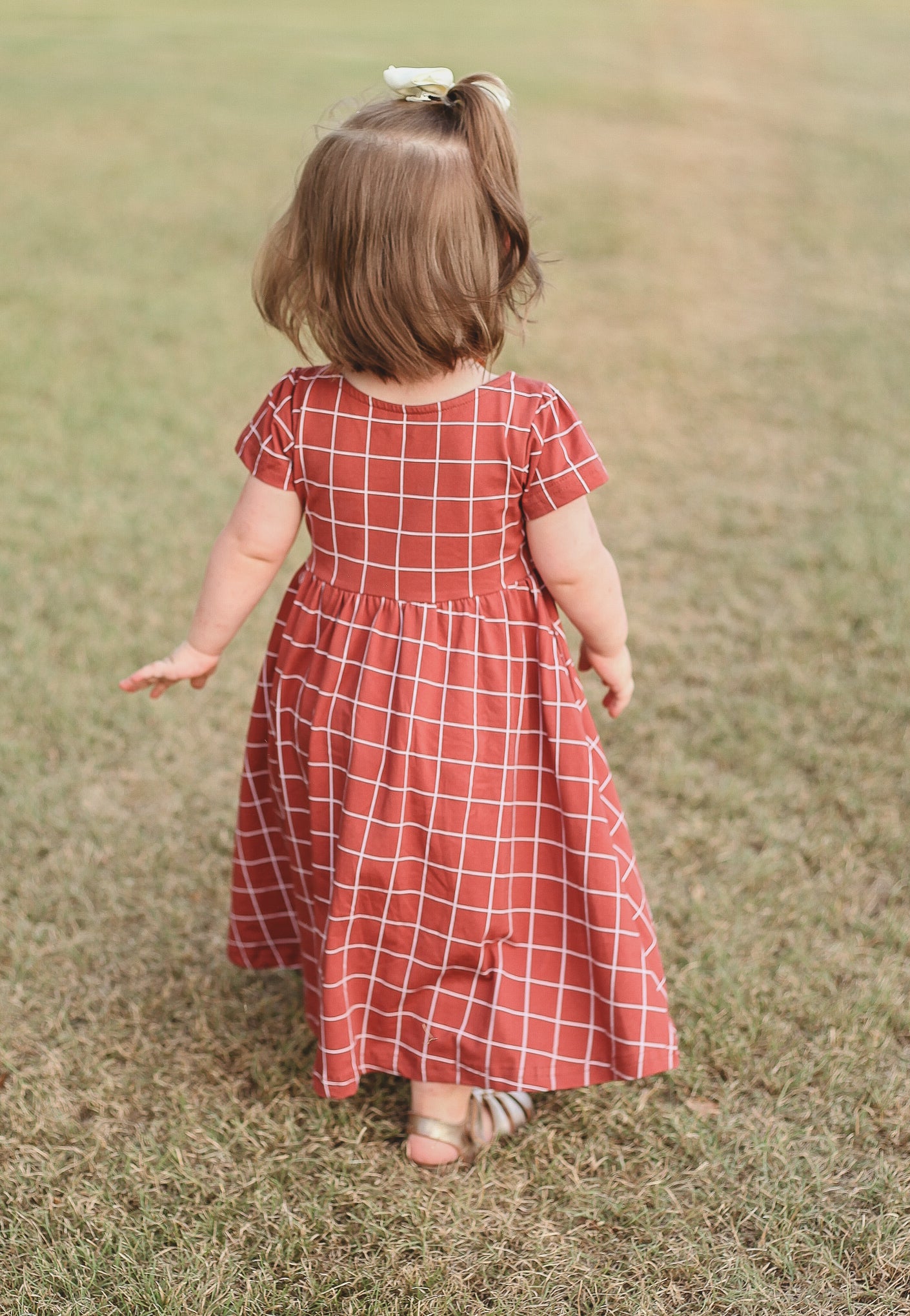 Girl in modest checkered dress, ready for nursing.