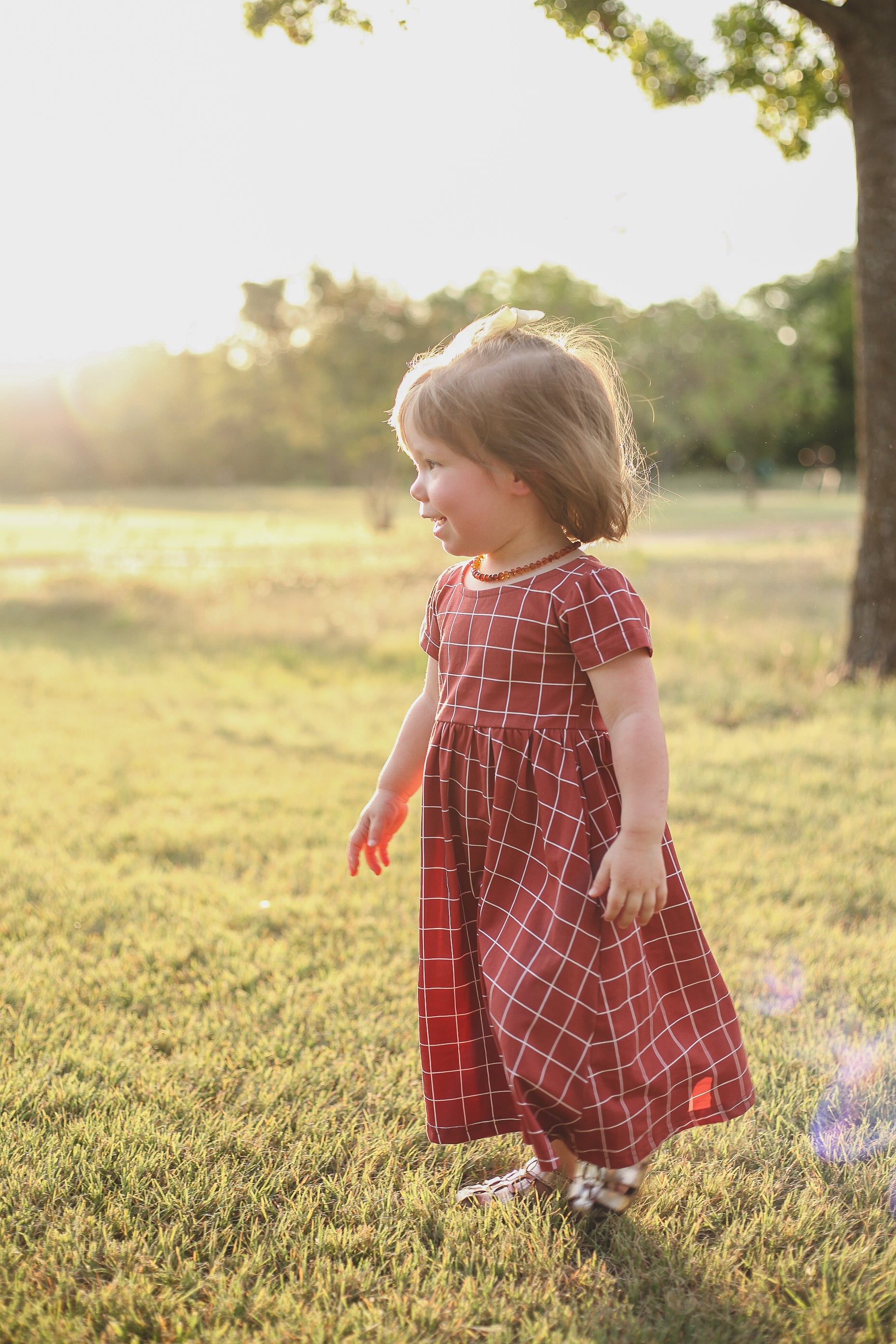 Girl in modest checkered dress, ready for nursing care.