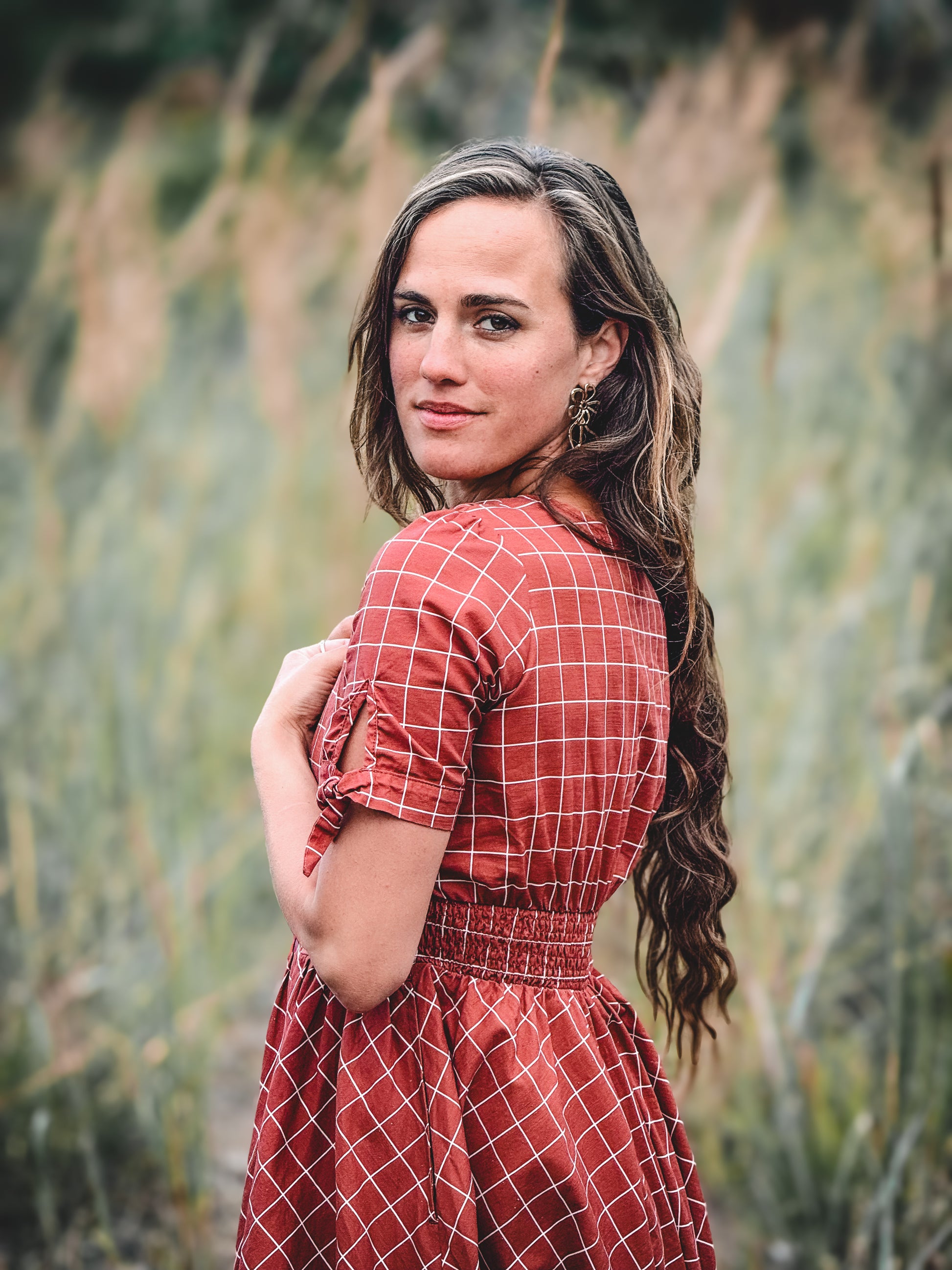 Woman in modest nursing red checkered dress outdoors