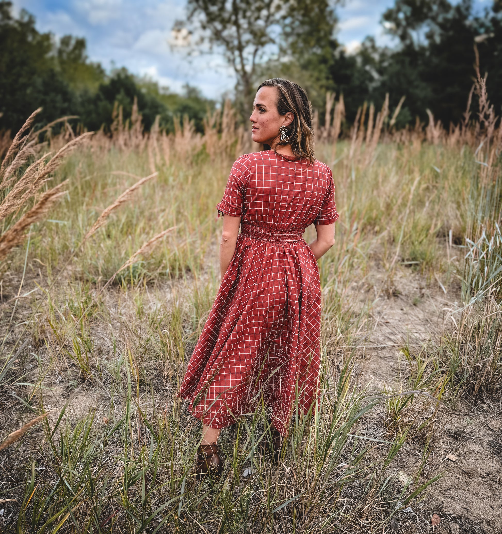 Woman in modest nursing red checkered dress outdoors