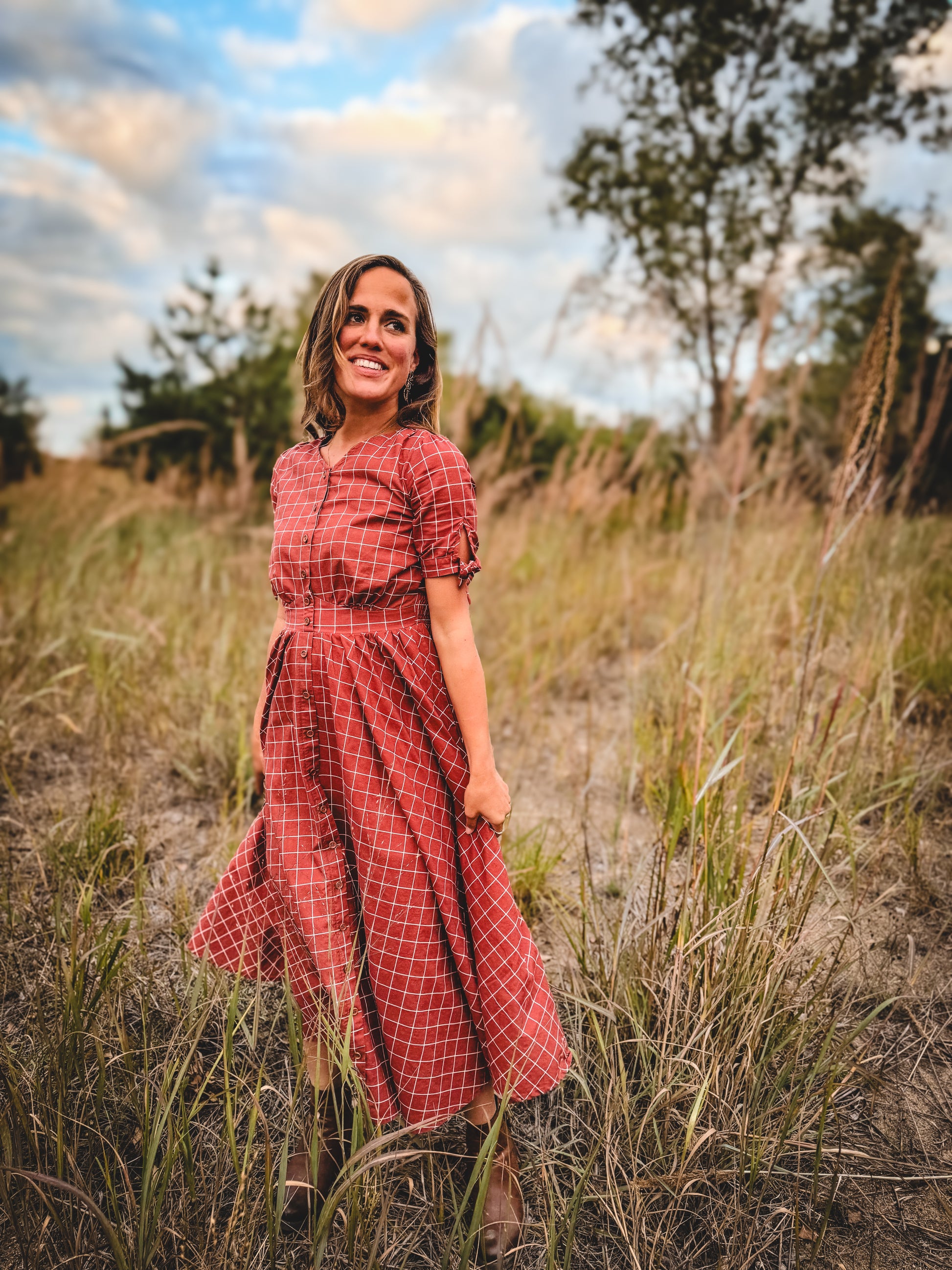 Woman in modest nursing red checkered dress outdoors