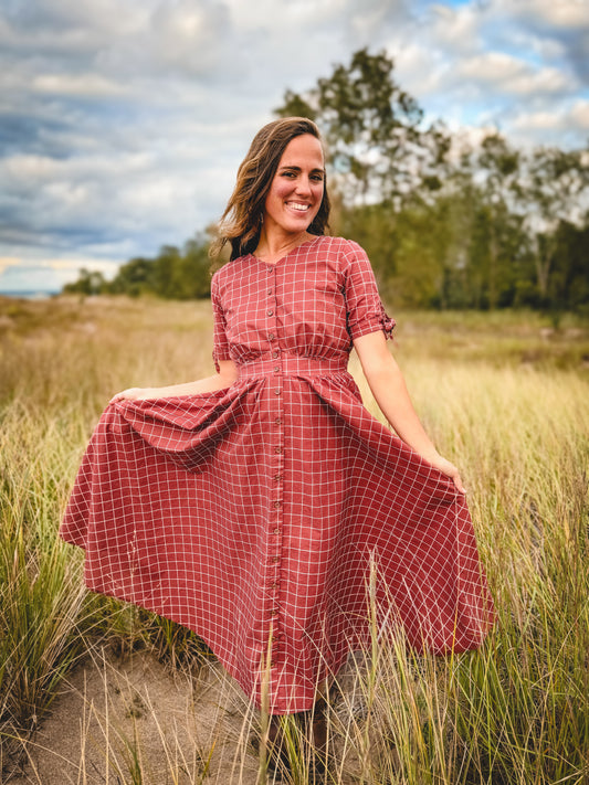 Woman in modest nursing checkered dress outdoors