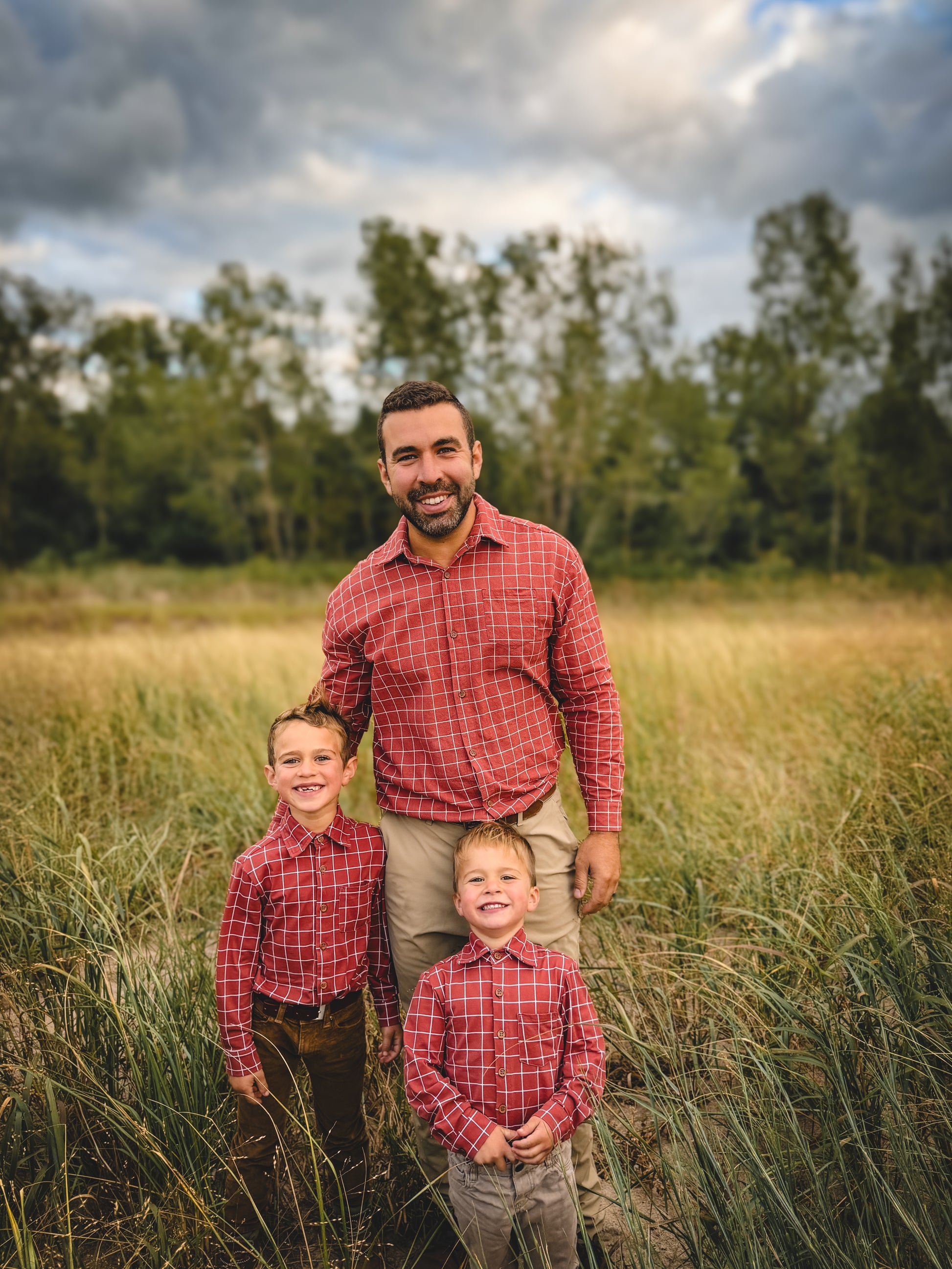 Father with two children matching plaid outdoors