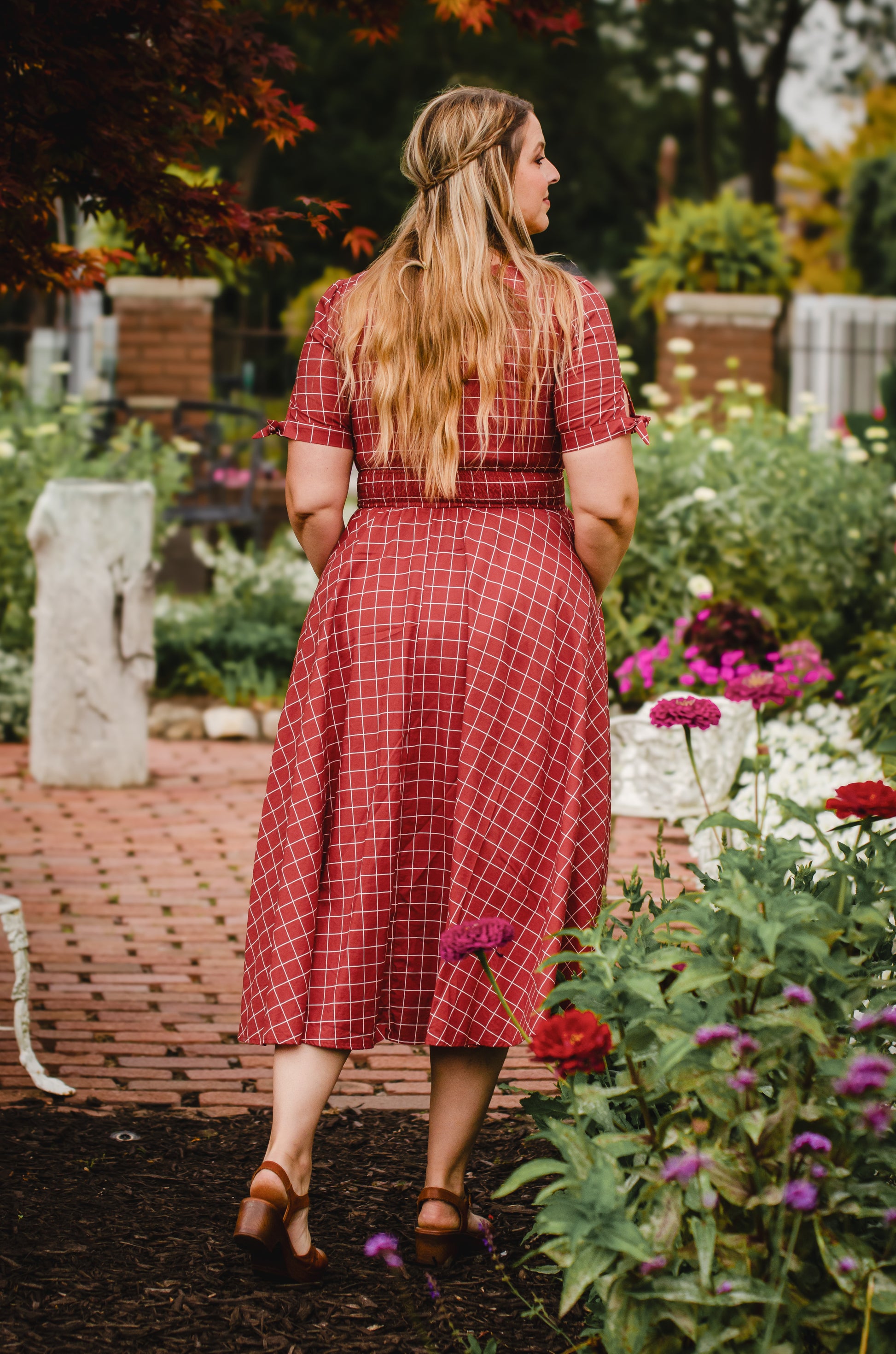 Woman in modest nursing plaid dress garden