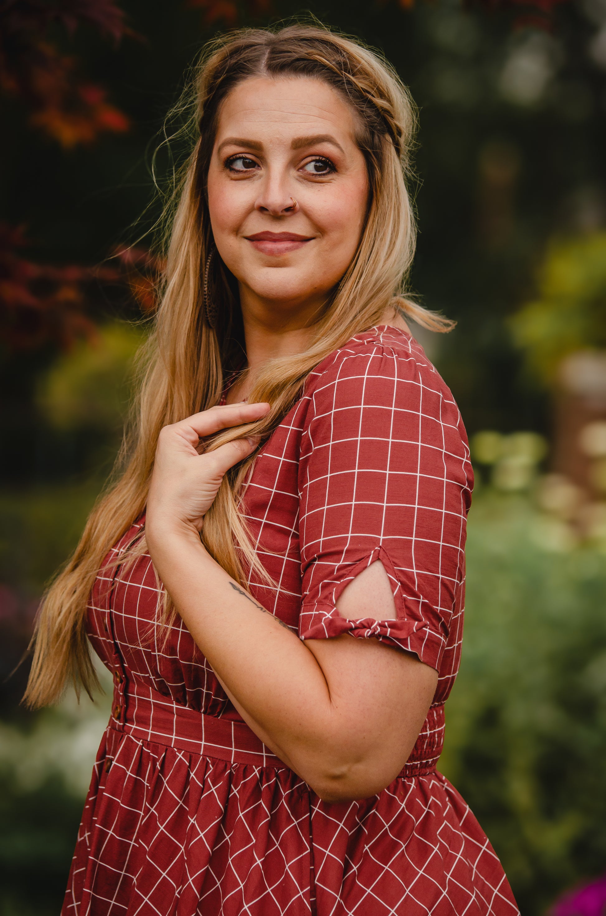 Woman in modest nursing red checkered dress outdoors