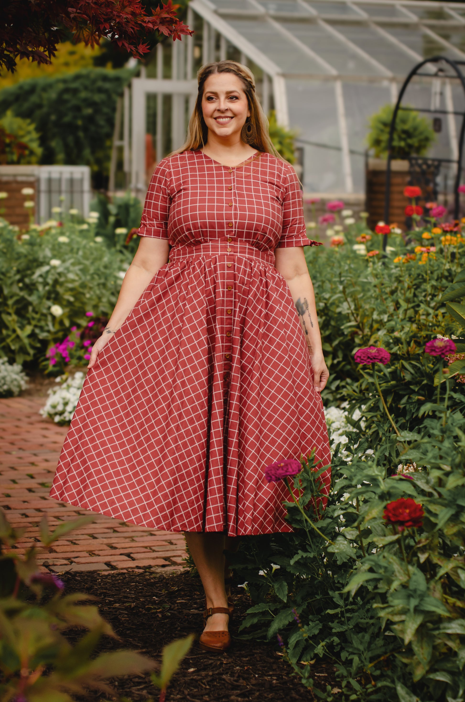 Woman in modest nursing red checkered dress garden