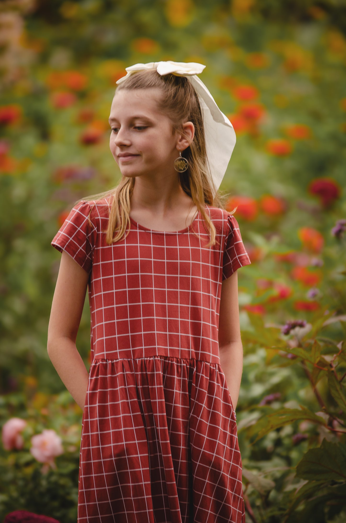 Girl in modest checkered dress, ready for nursing.