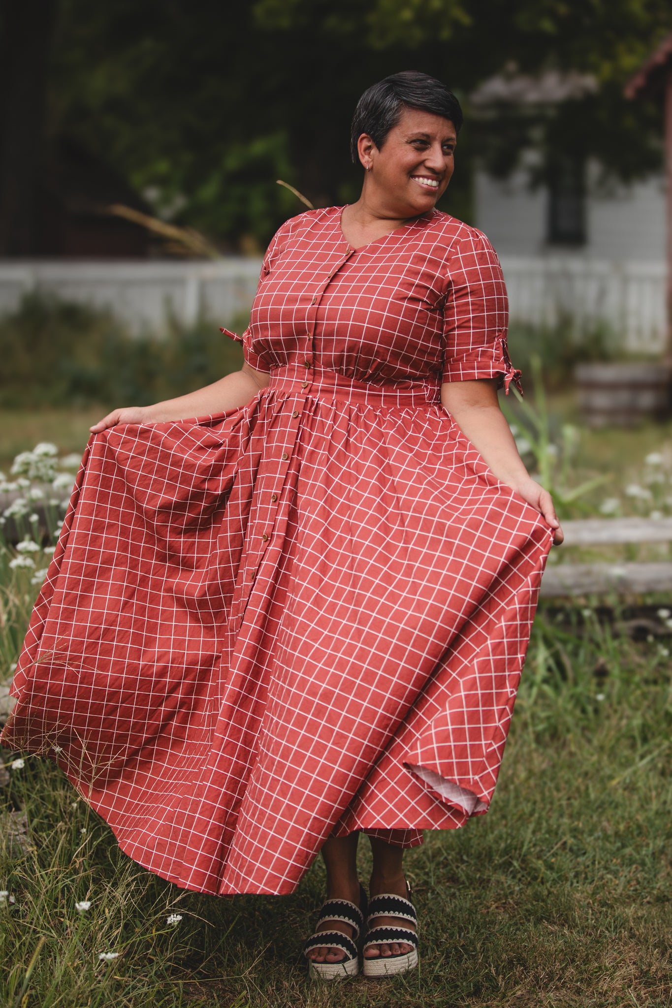 Woman in modest nursing checkered dress outdoors