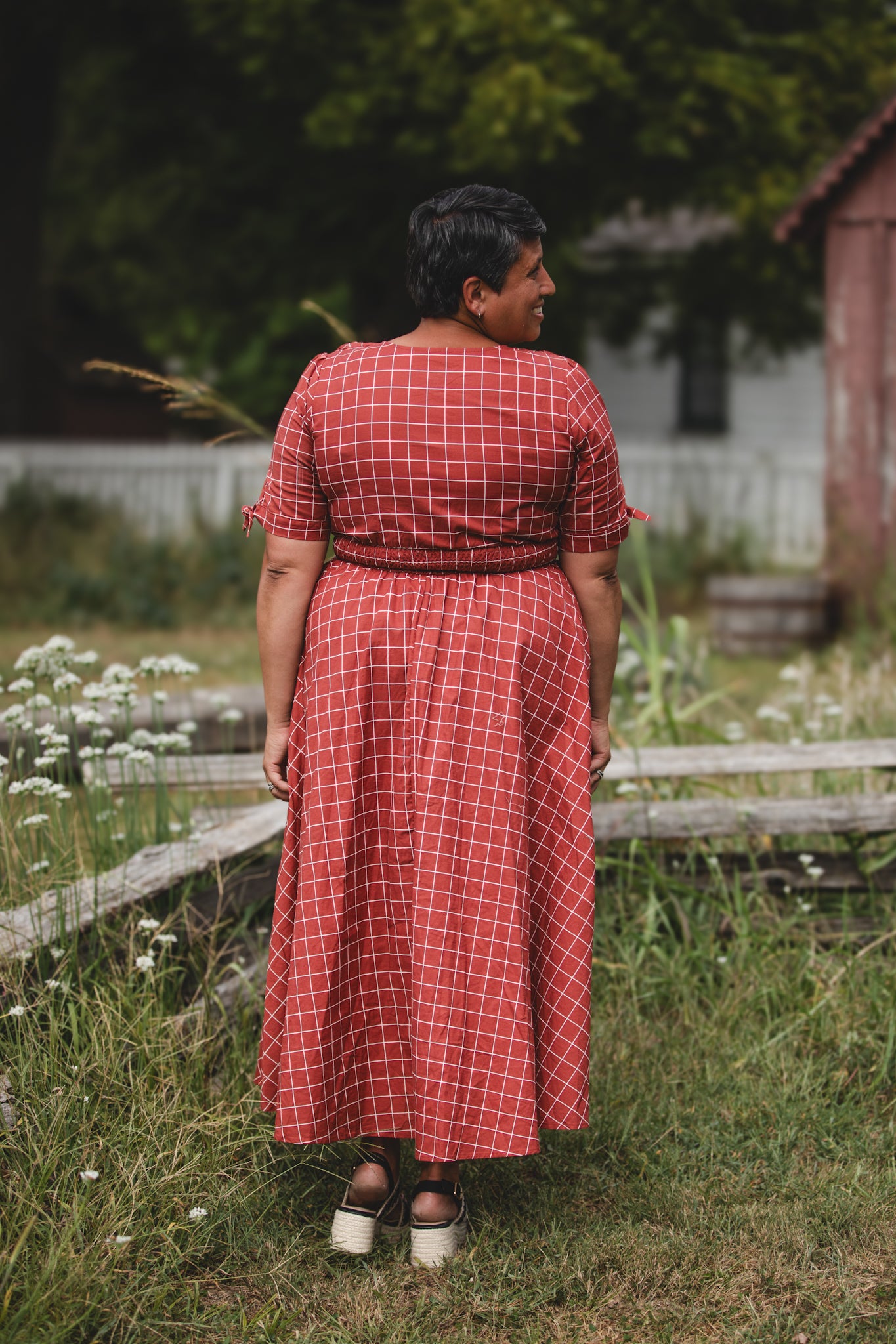 Woman in modest nursing checkered dress outdoors