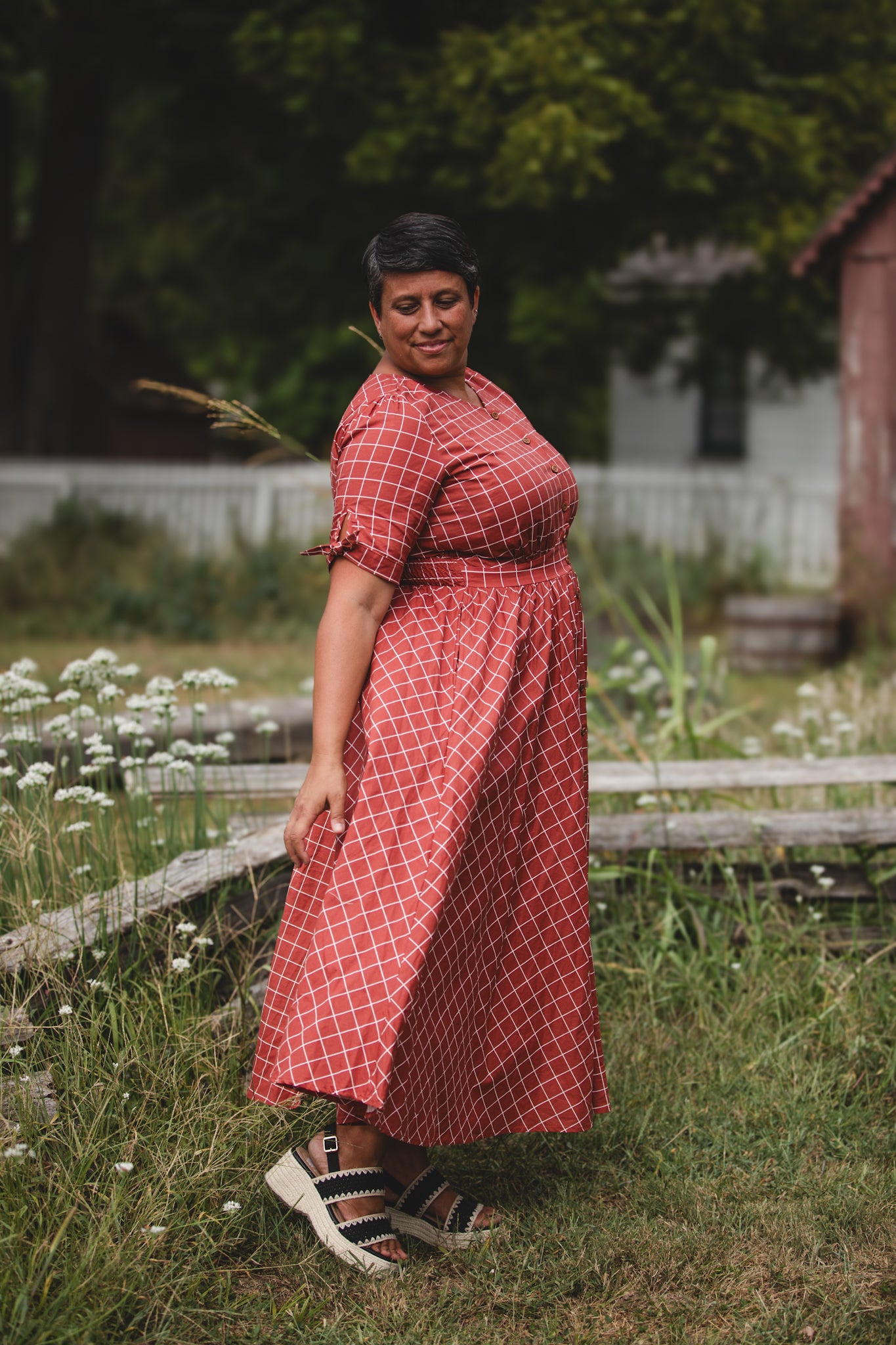 Woman in modest nursing checkered dress outdoors