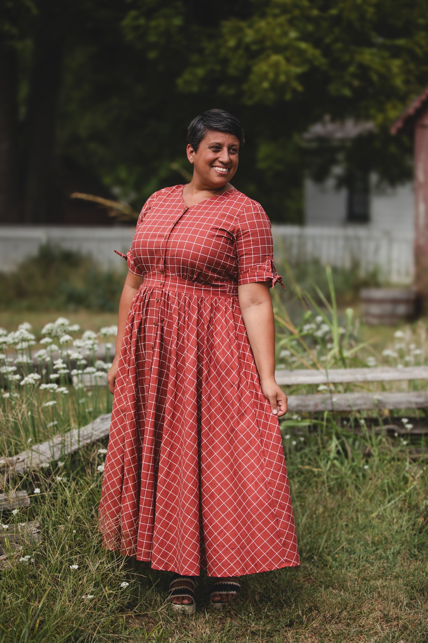 Woman in modest nursing red checkered dress outdoors