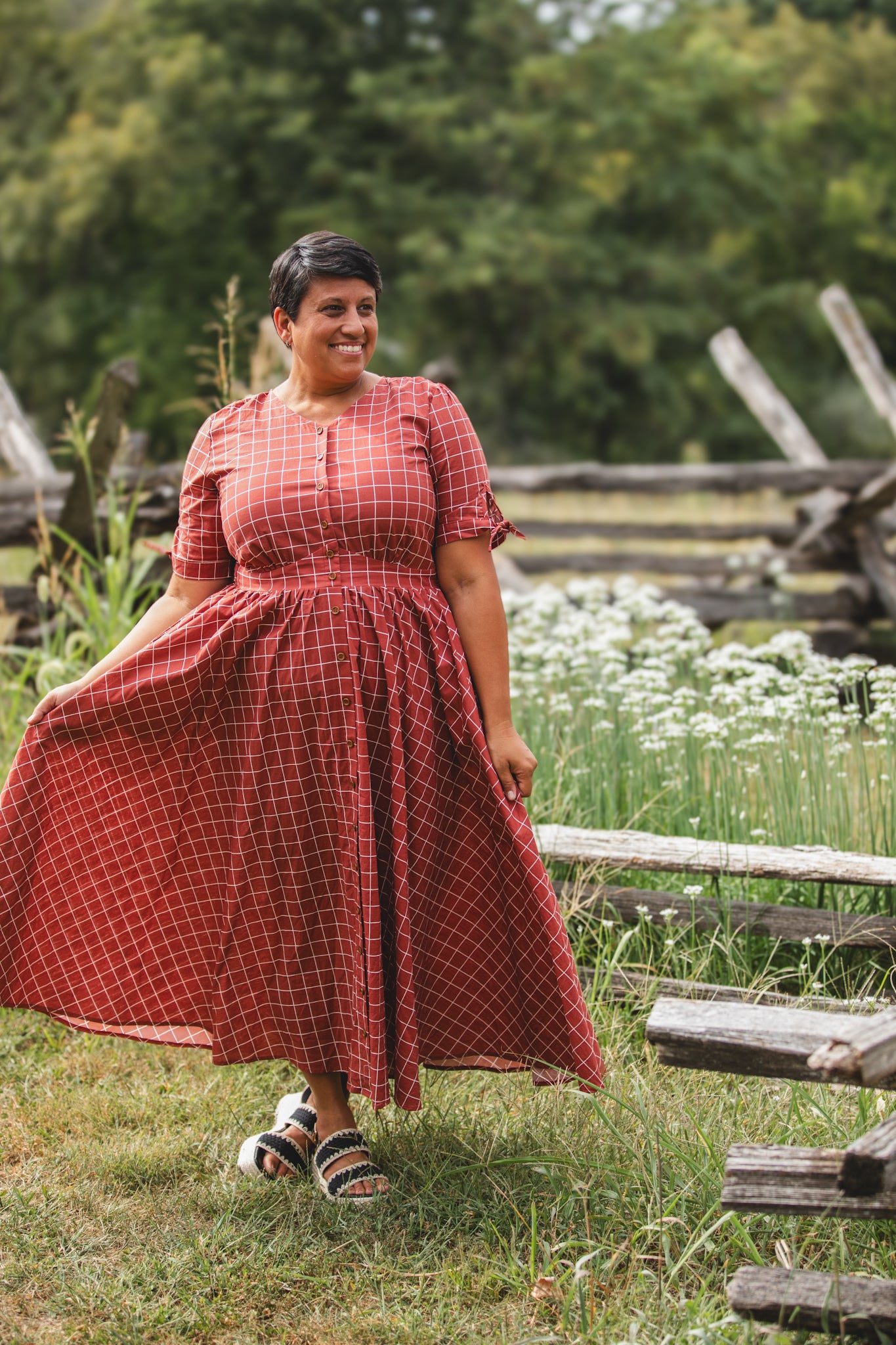 Woman in modest nursing red checkered dress garden