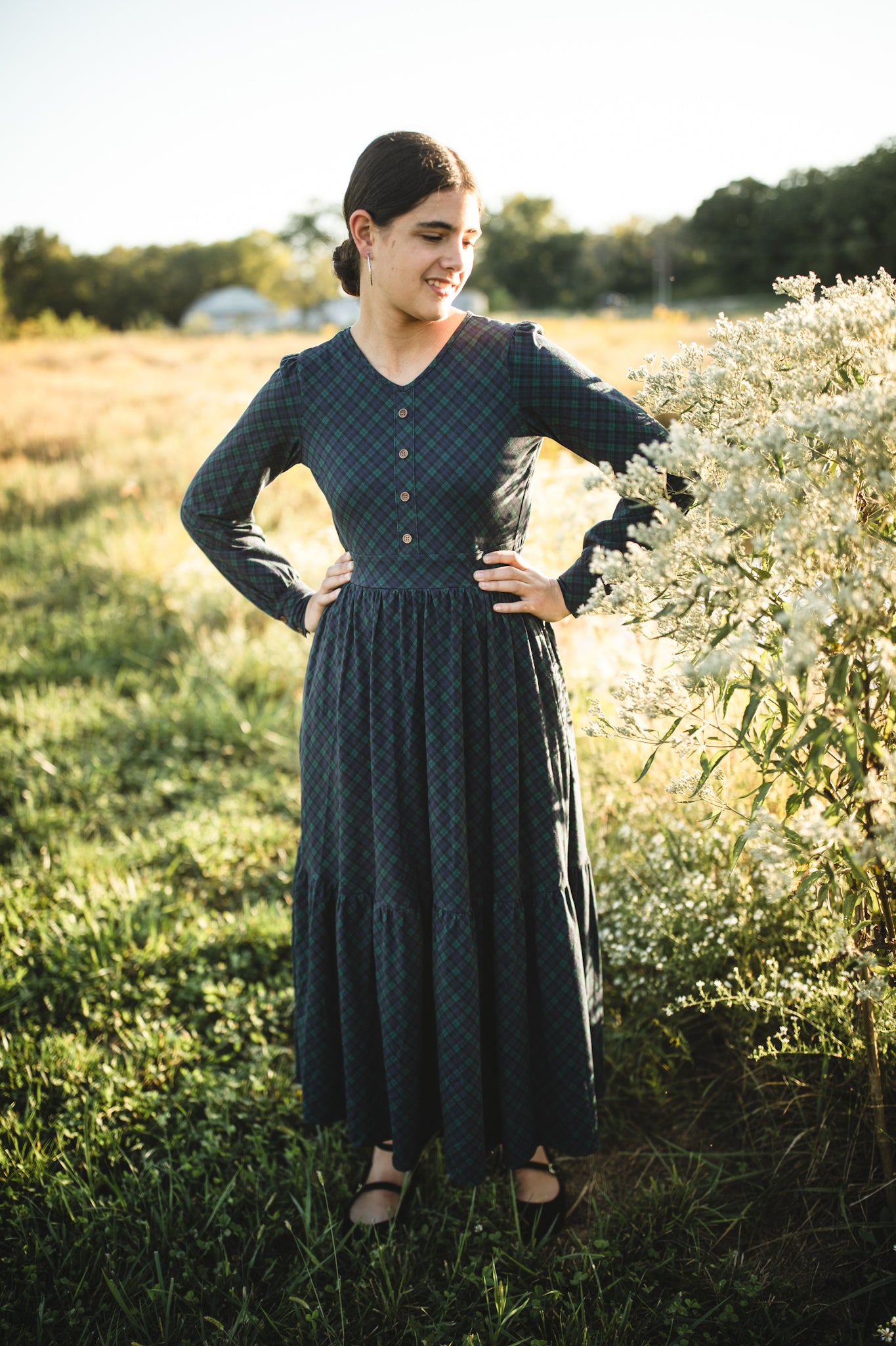 Woman in modest nursing dress white flowers outdoors