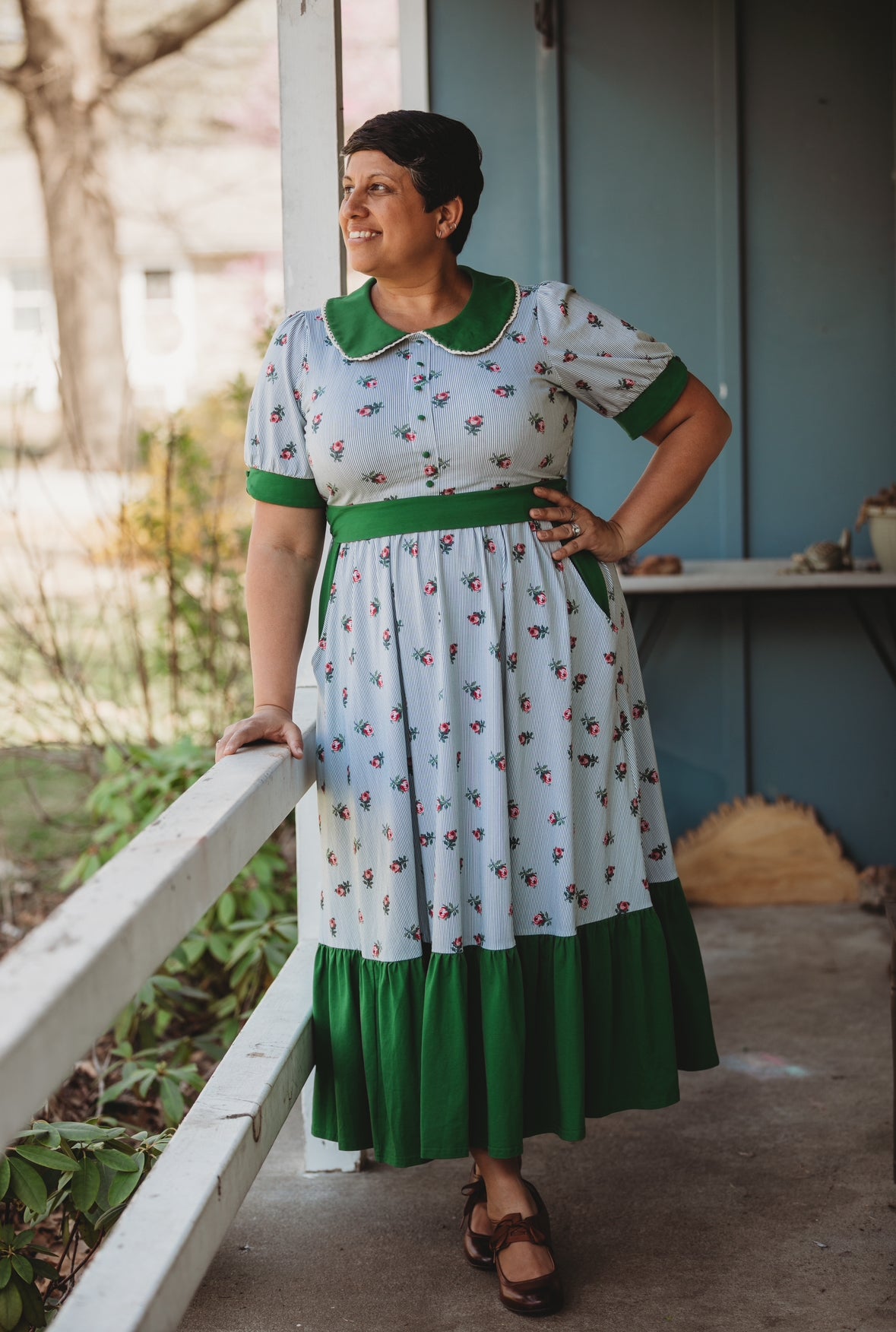 woman wearing a green and white striped modest nursing dress