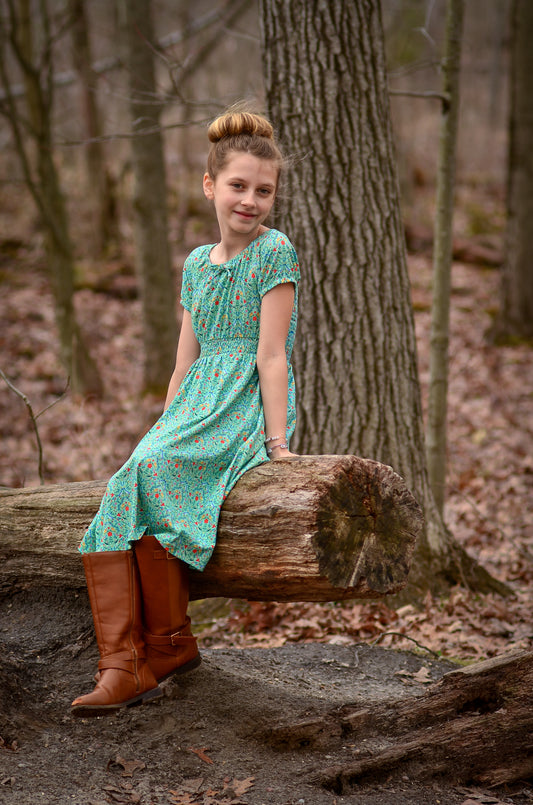 Young girl wearing a modest green dress