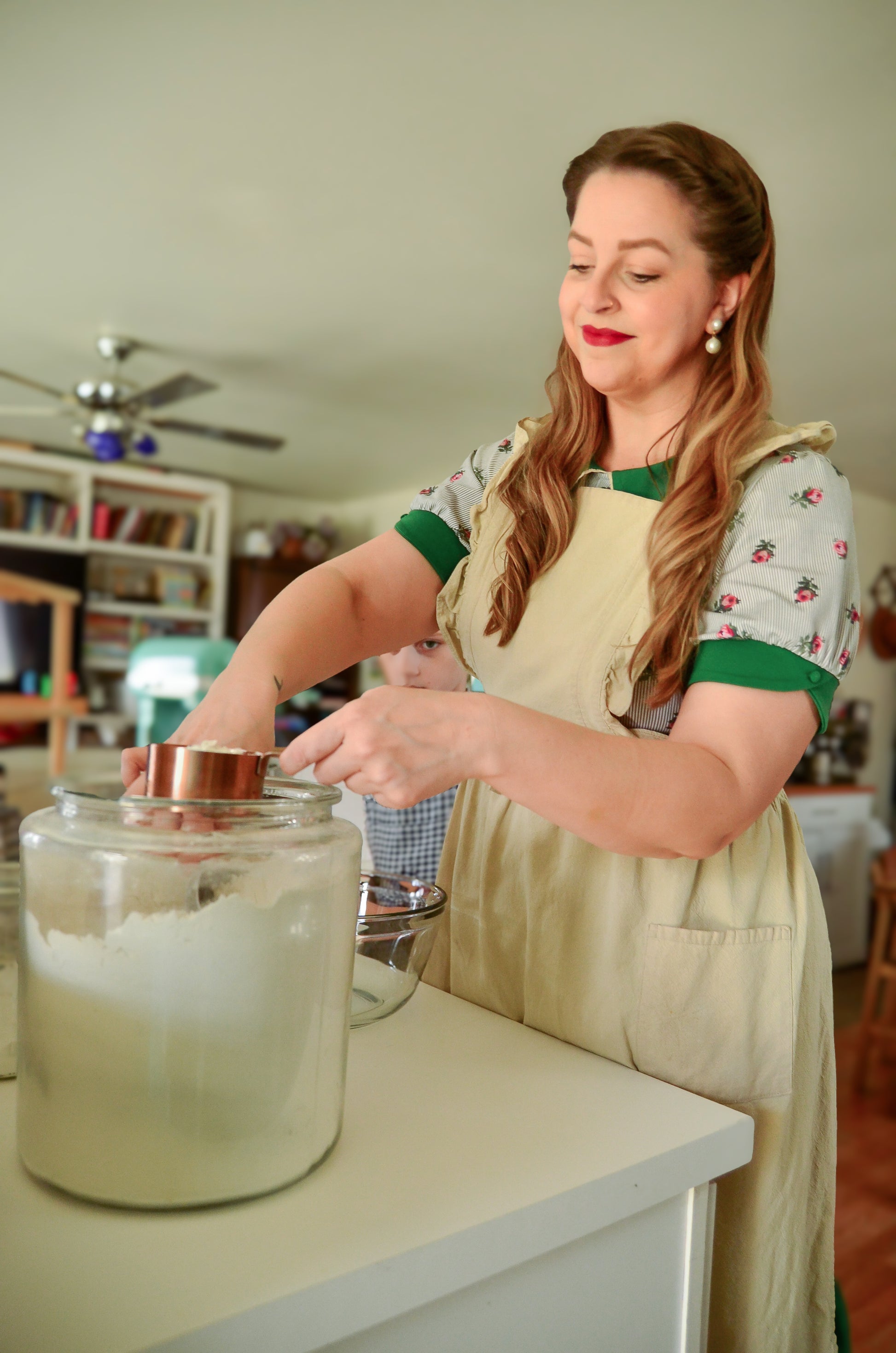 woman wearing a green and white striped modest nursing dress