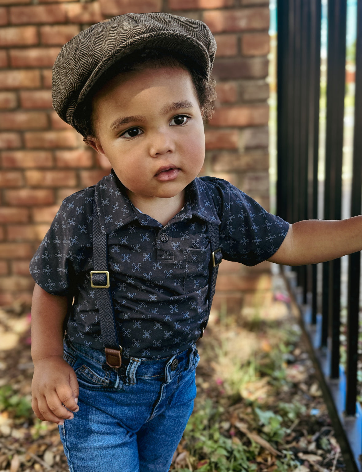 Young boy wearing a dark blue polo shirt