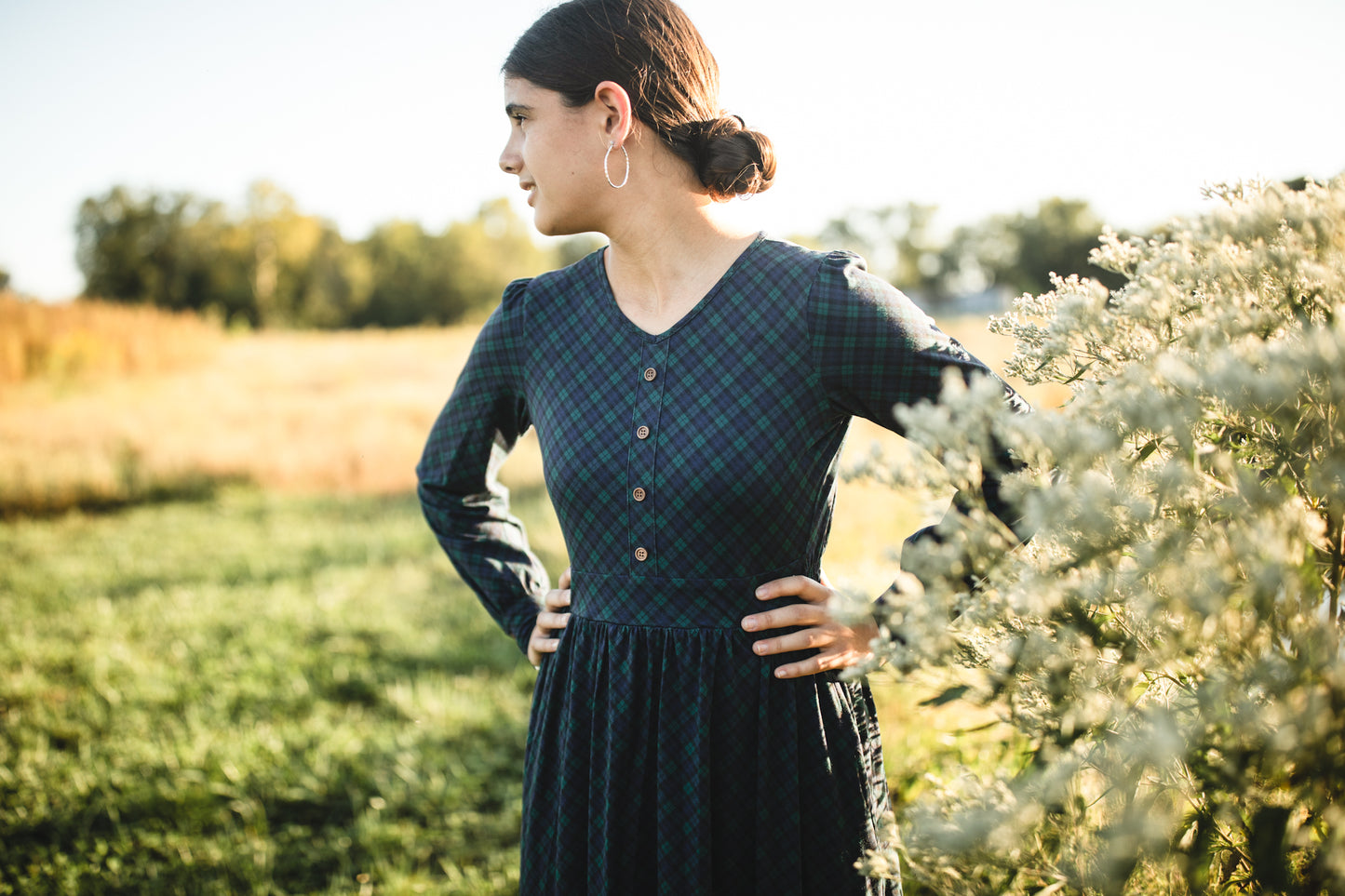 Woman in modest nursing dark green dress outdoors
