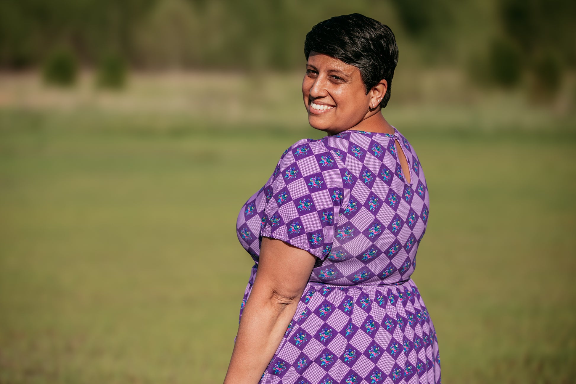 woman wearing patterned purple modest nursing dress