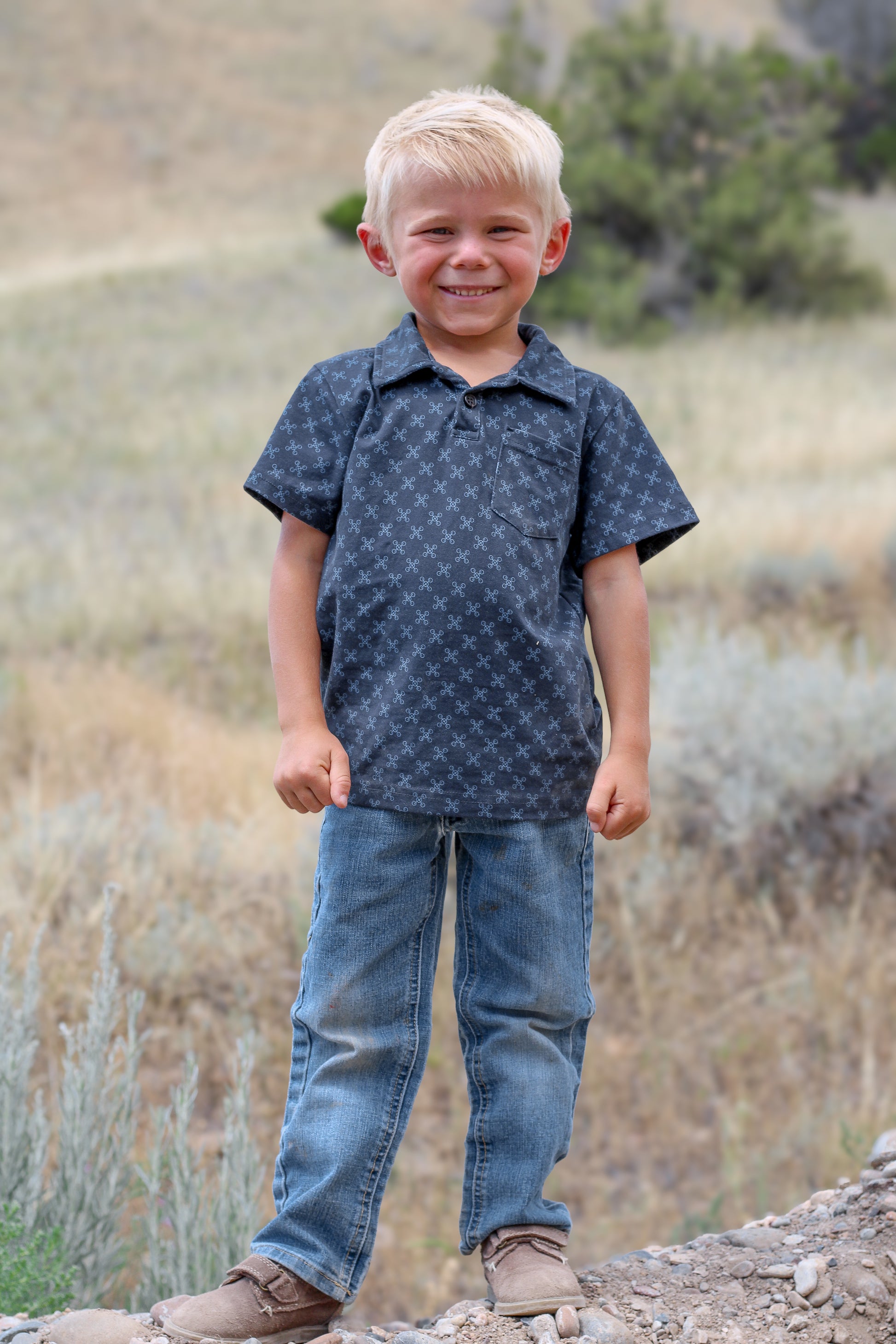 Young boy wearing a dark blue polo shirt