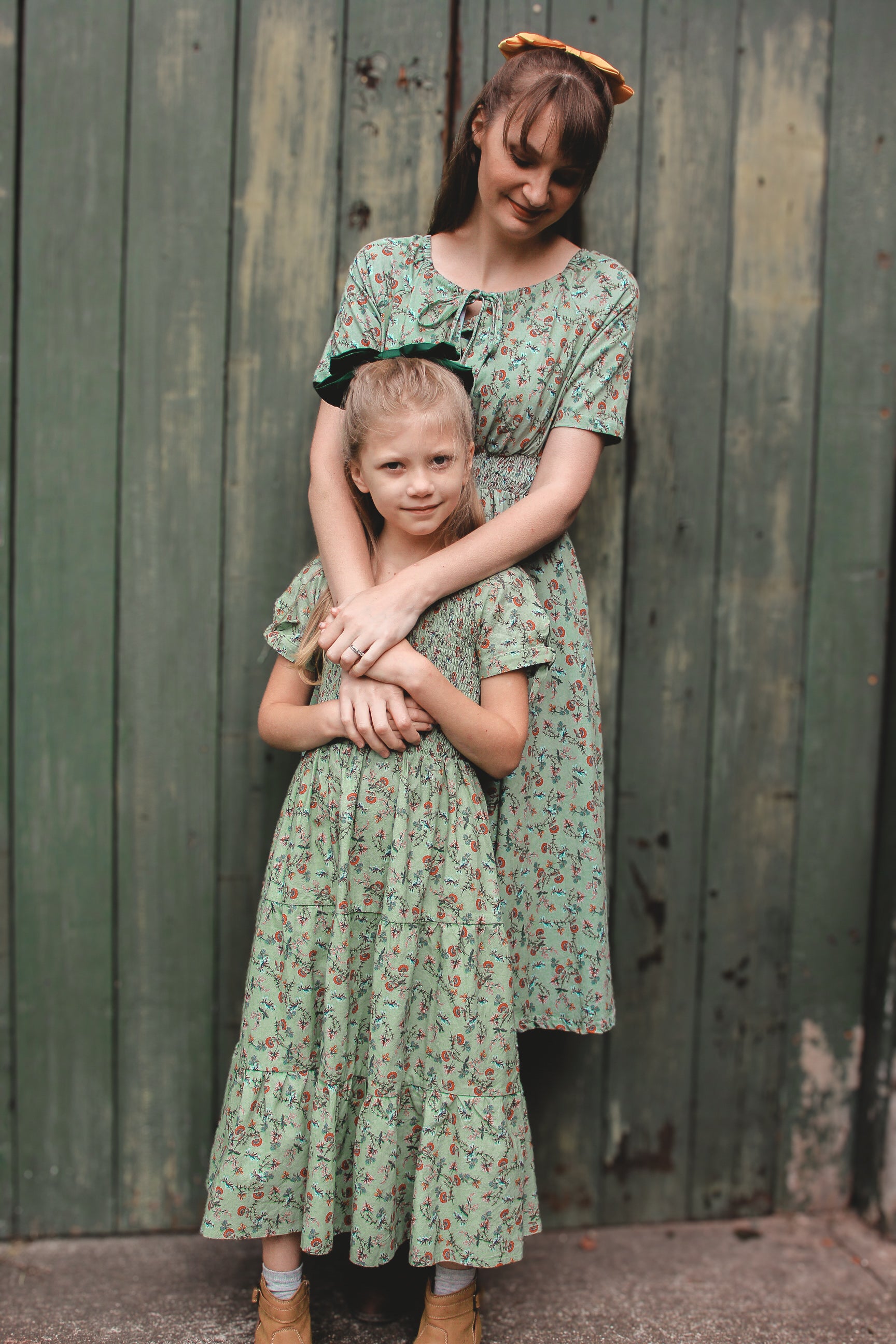 woman wearing a modest nursing green floral dress with her daughter
