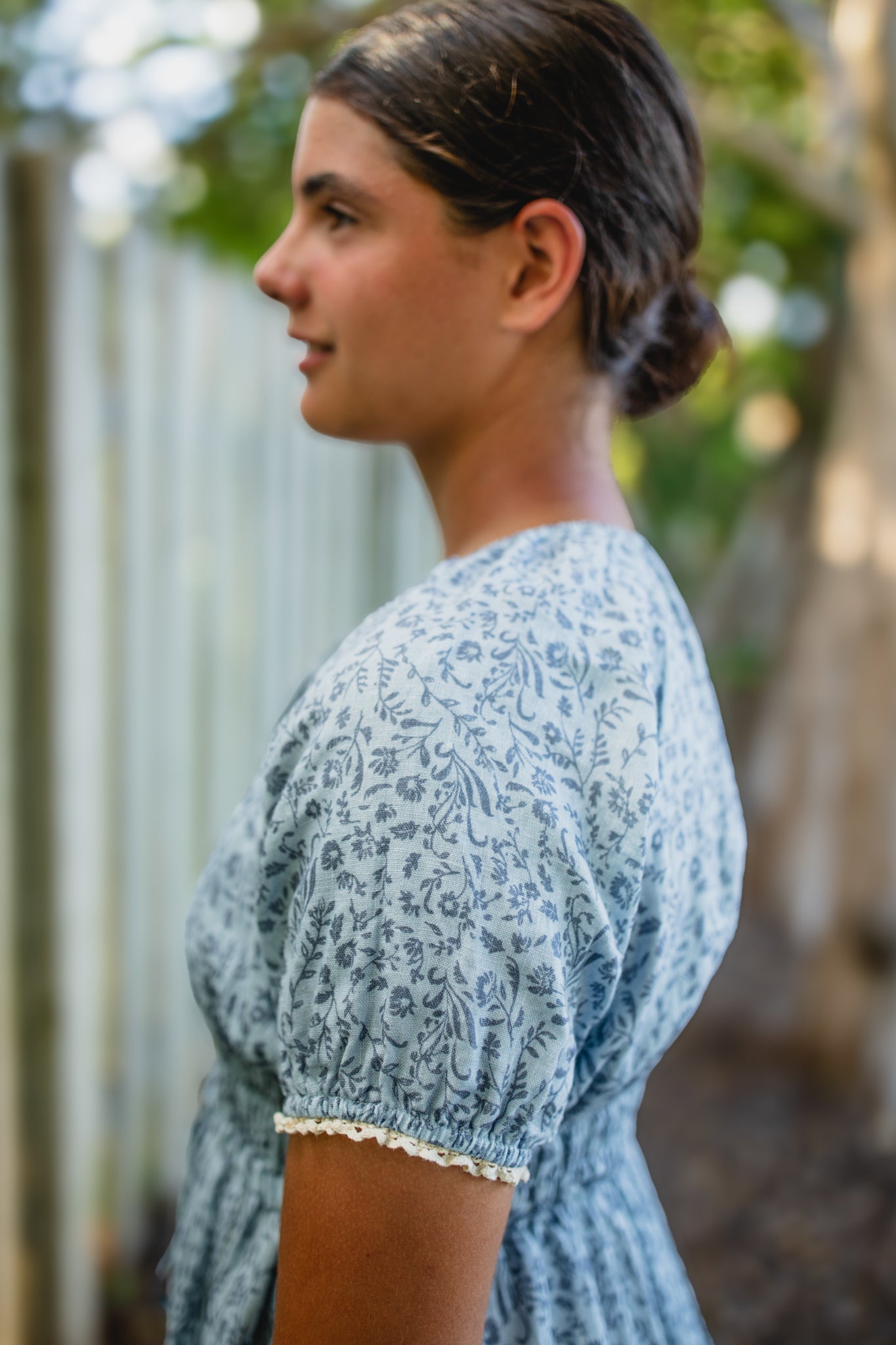 woman in a modest blue nursing dress