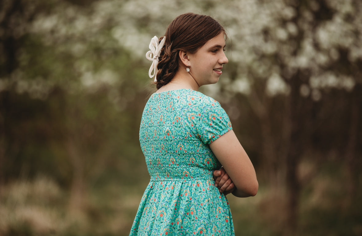 Young girl wearing a modest green dress