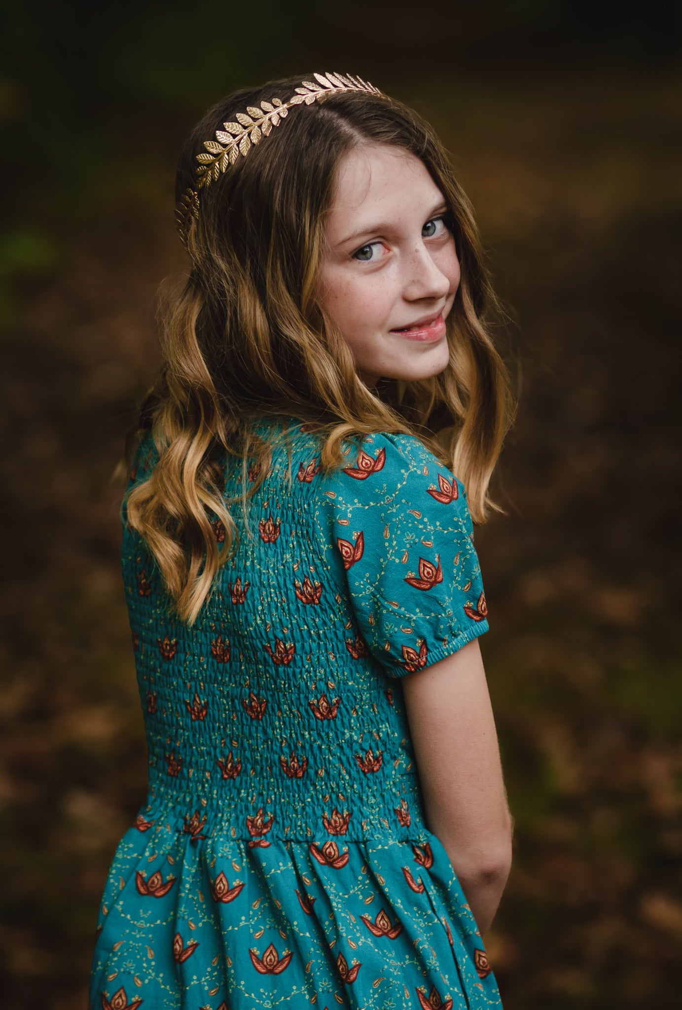 Young girl in modest dress with floral patterns.