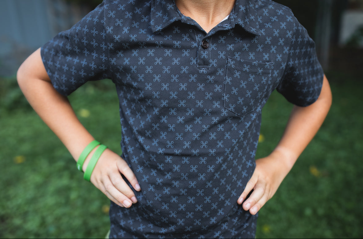 Young boy wearing a dark blue polo shirt