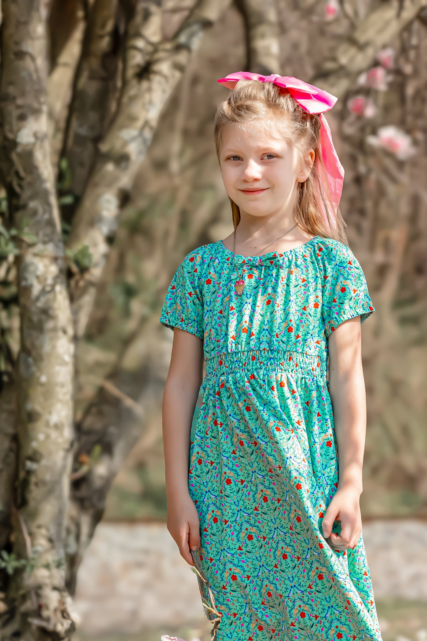 Young girl wearing a modest green dress