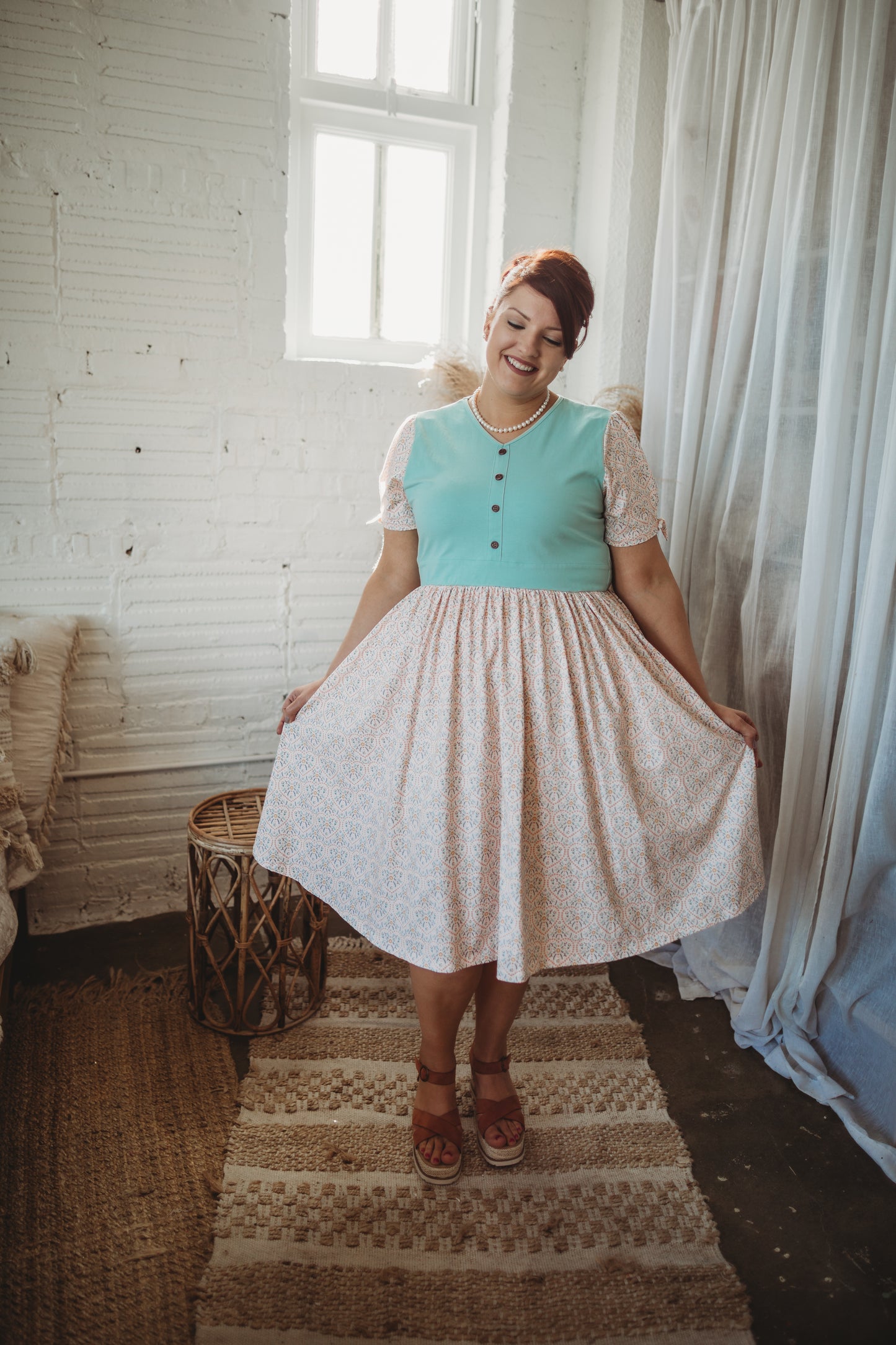 A woman wearing a vintage style modest nursing dress.