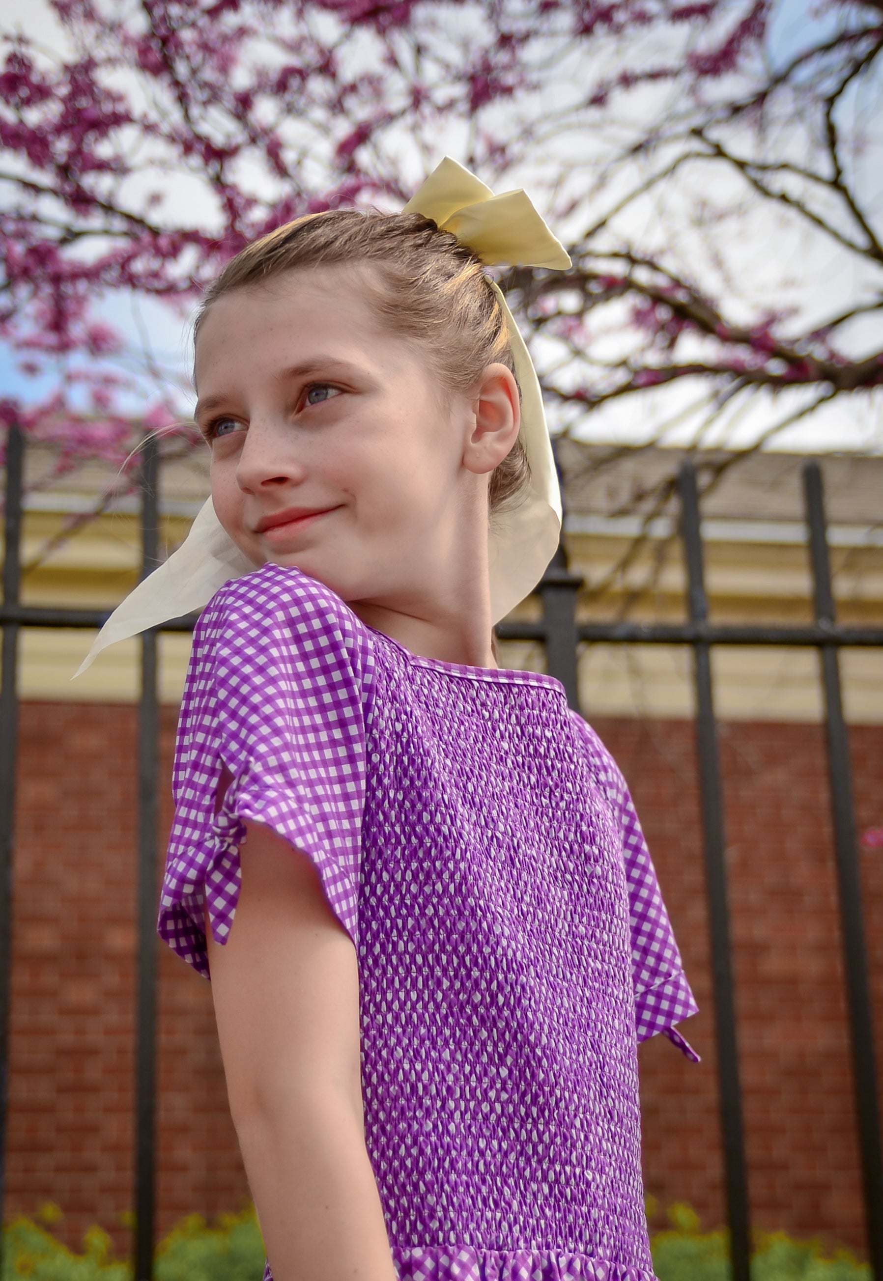 Young girl wearing a modest purple dress
