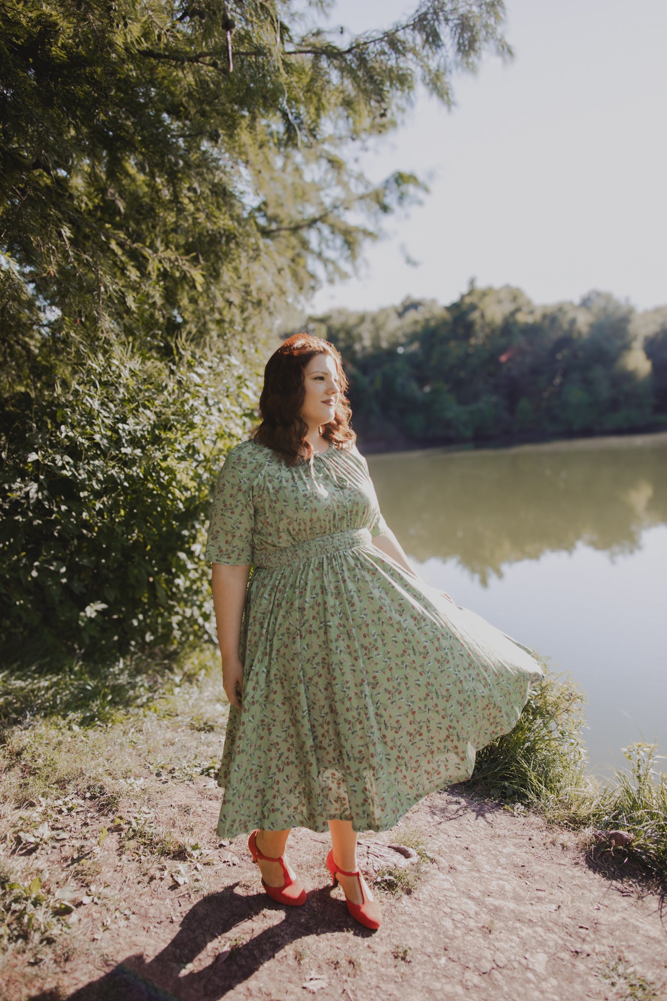 Woman in modest nursing dress by lake