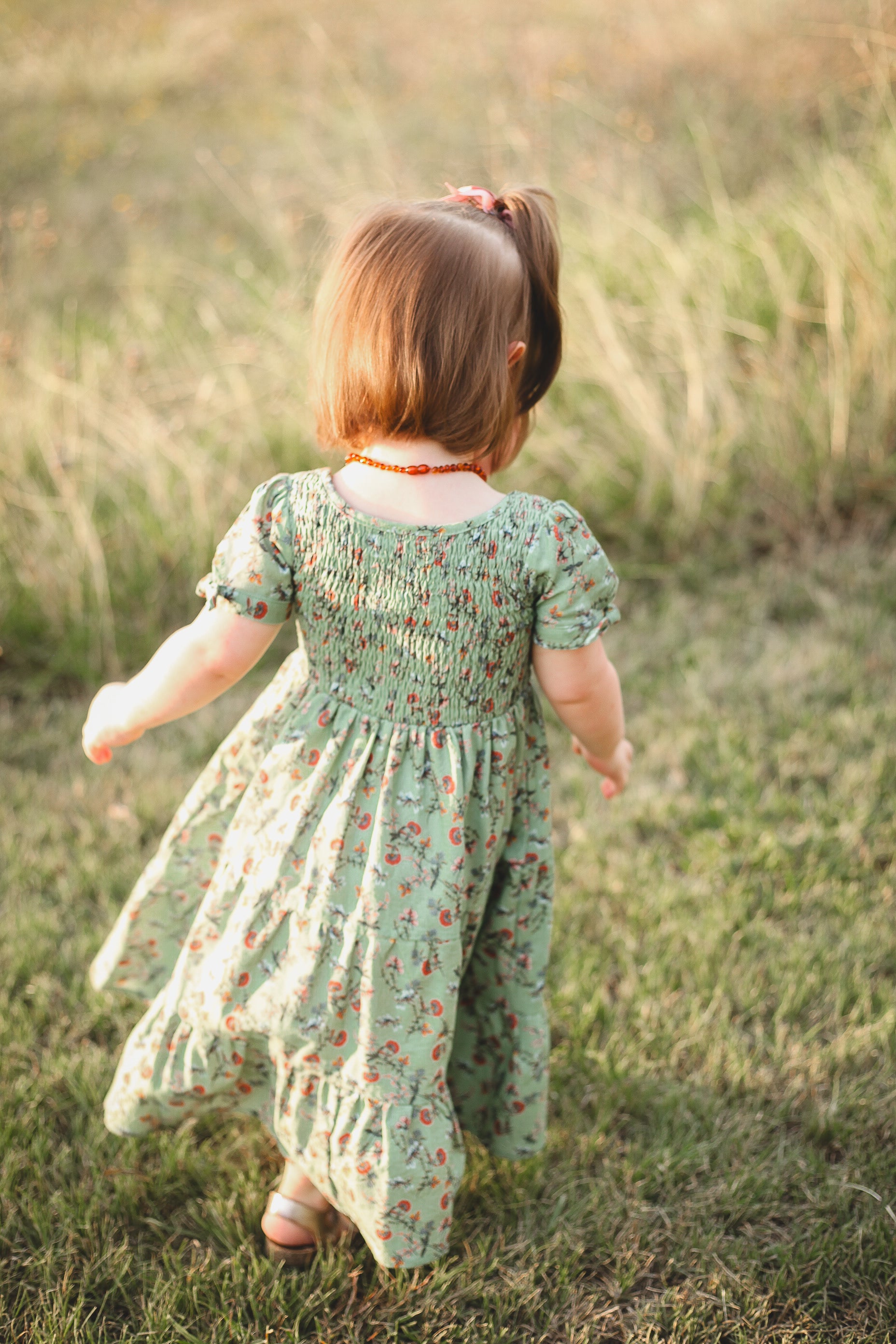 girl wearing a green floral dress
