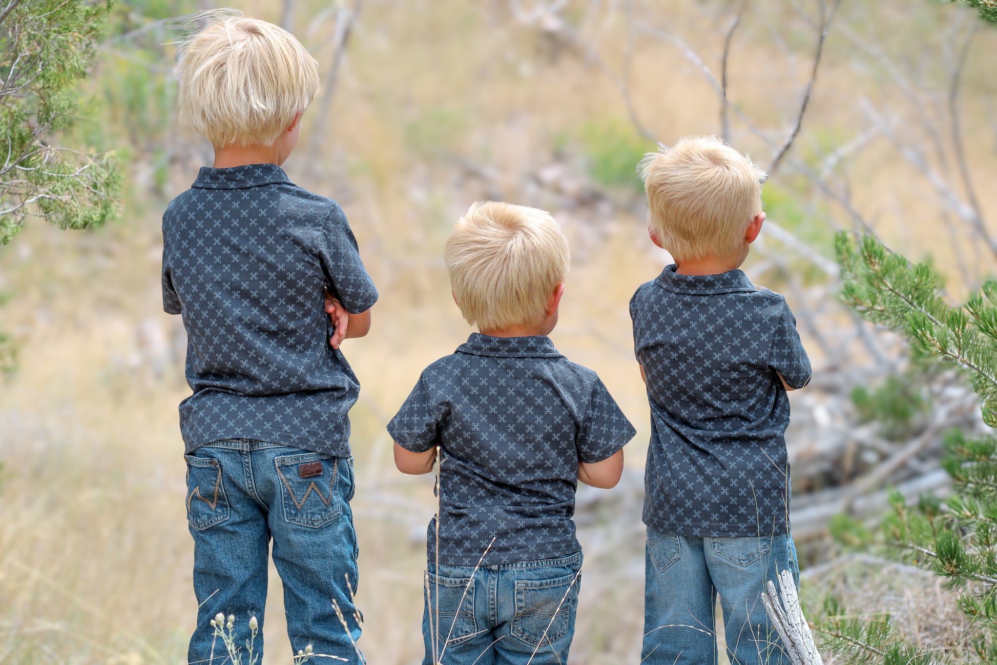 Young boys wearing dark blue polo shirts