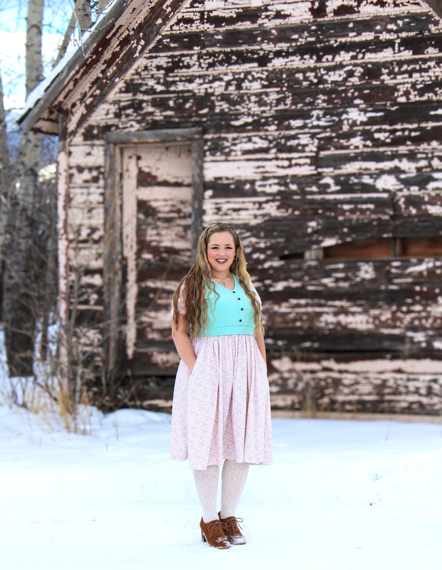 A woman wearing a vintage style modest nursing dress.