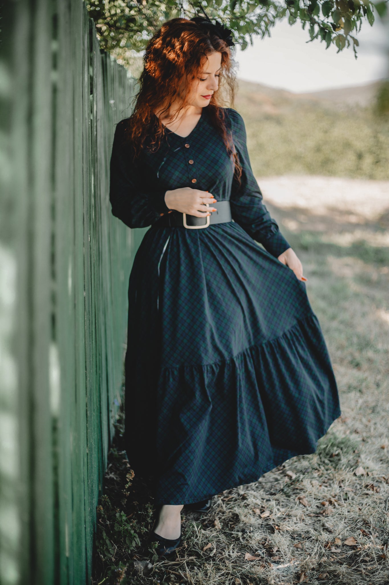 Woman in modest nursing dark green dress outdoors