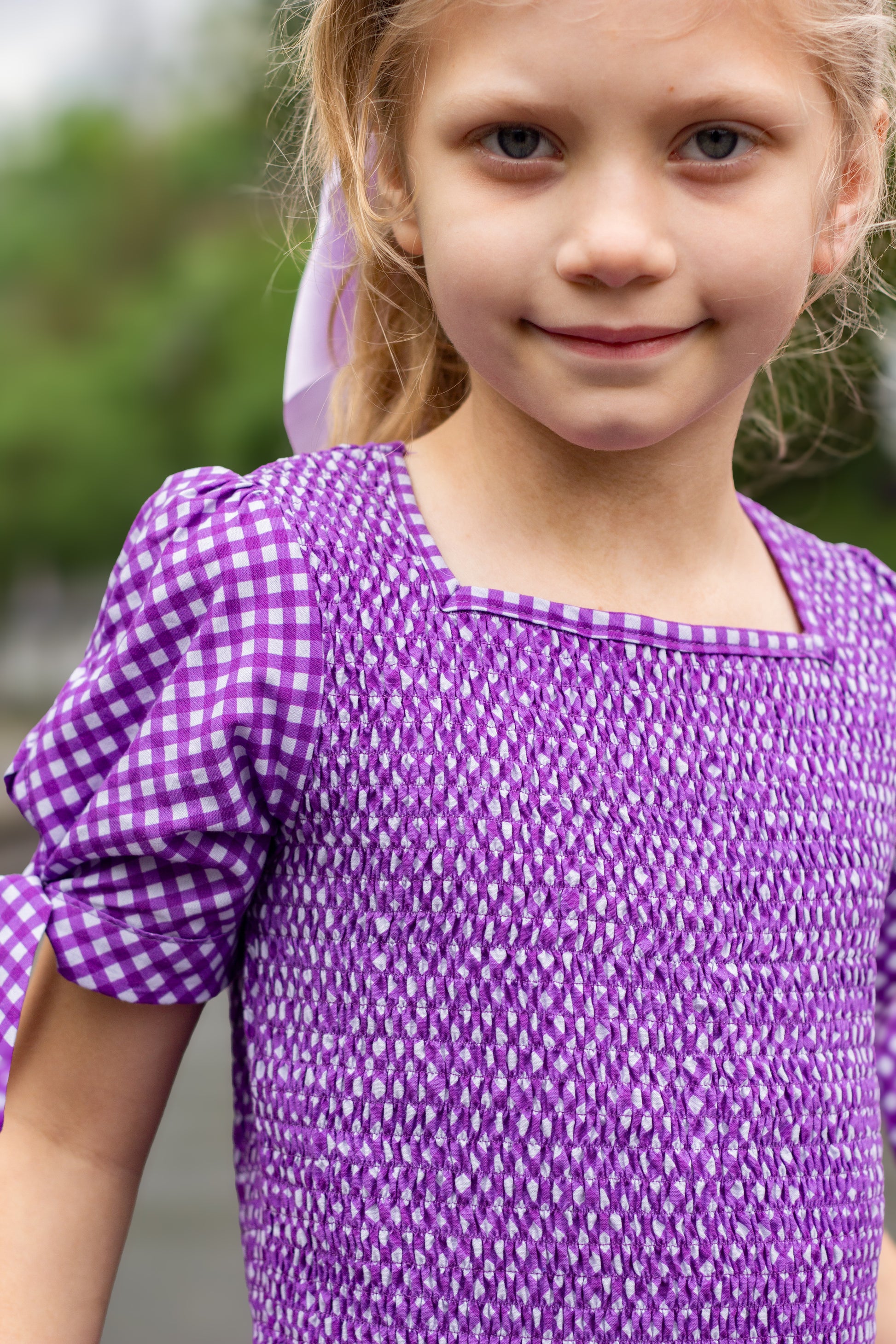 Young girl wearing a modest purple dress