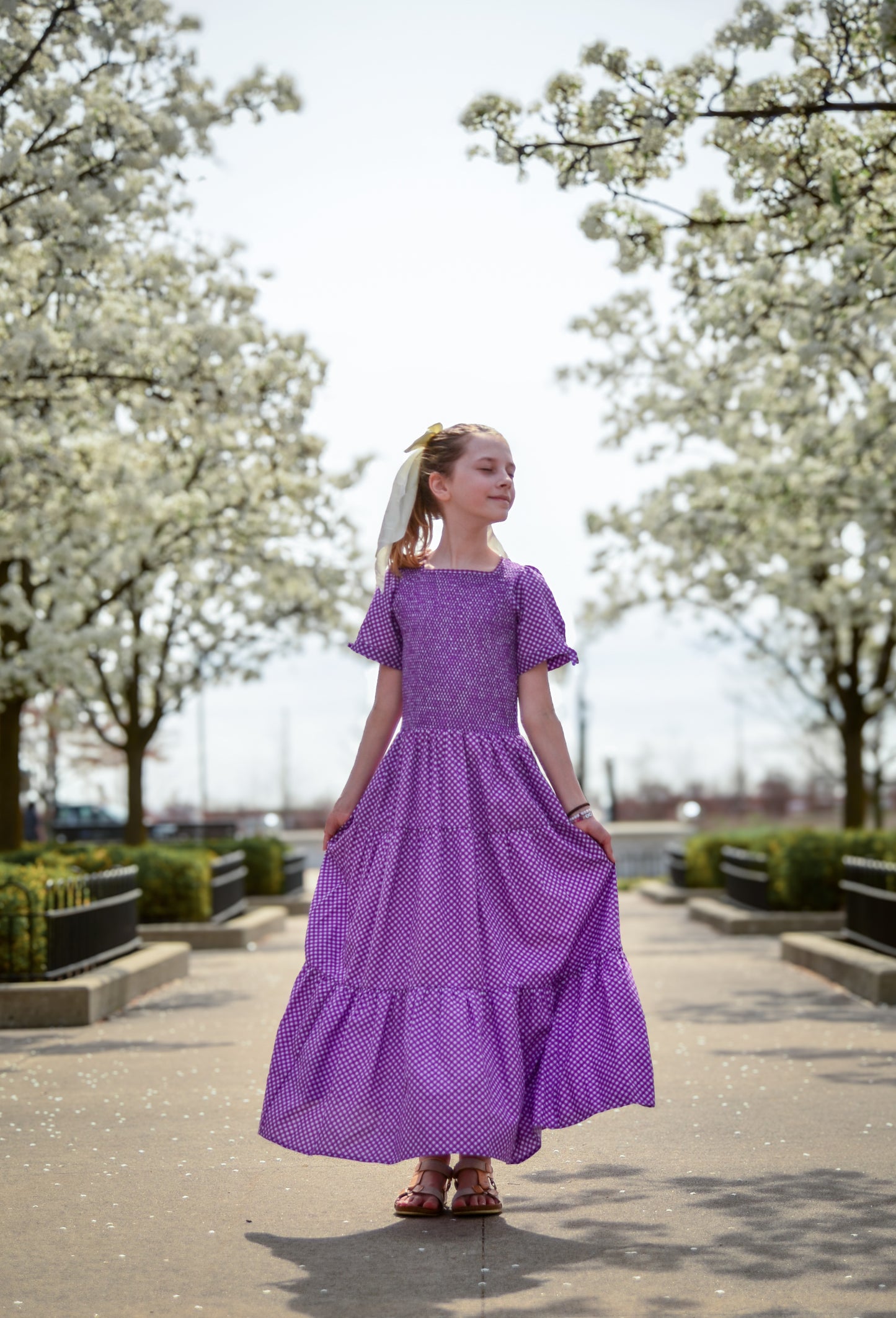 Young girl wearing a modest purple dress