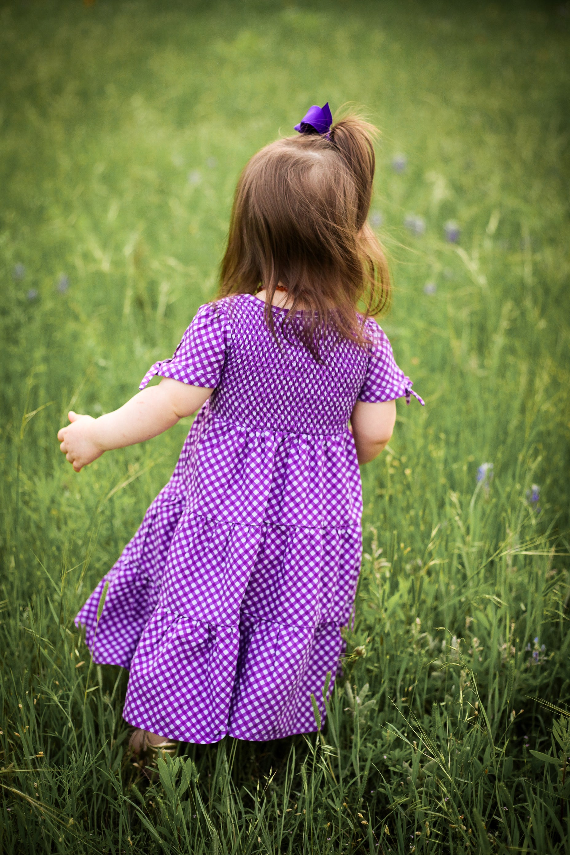 Young girl wearing a modest purple dress