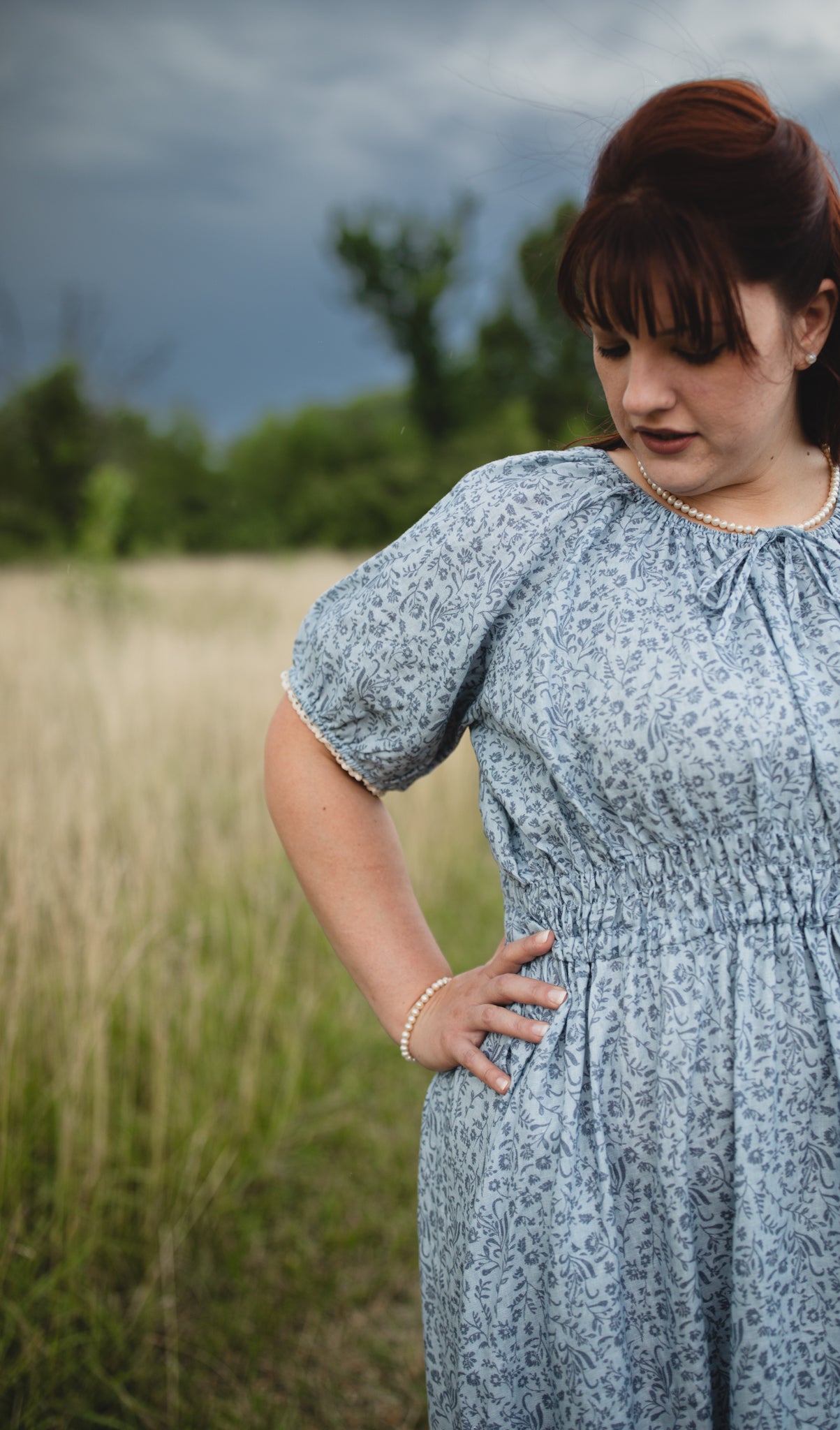 woman in a modest blue nursing dress