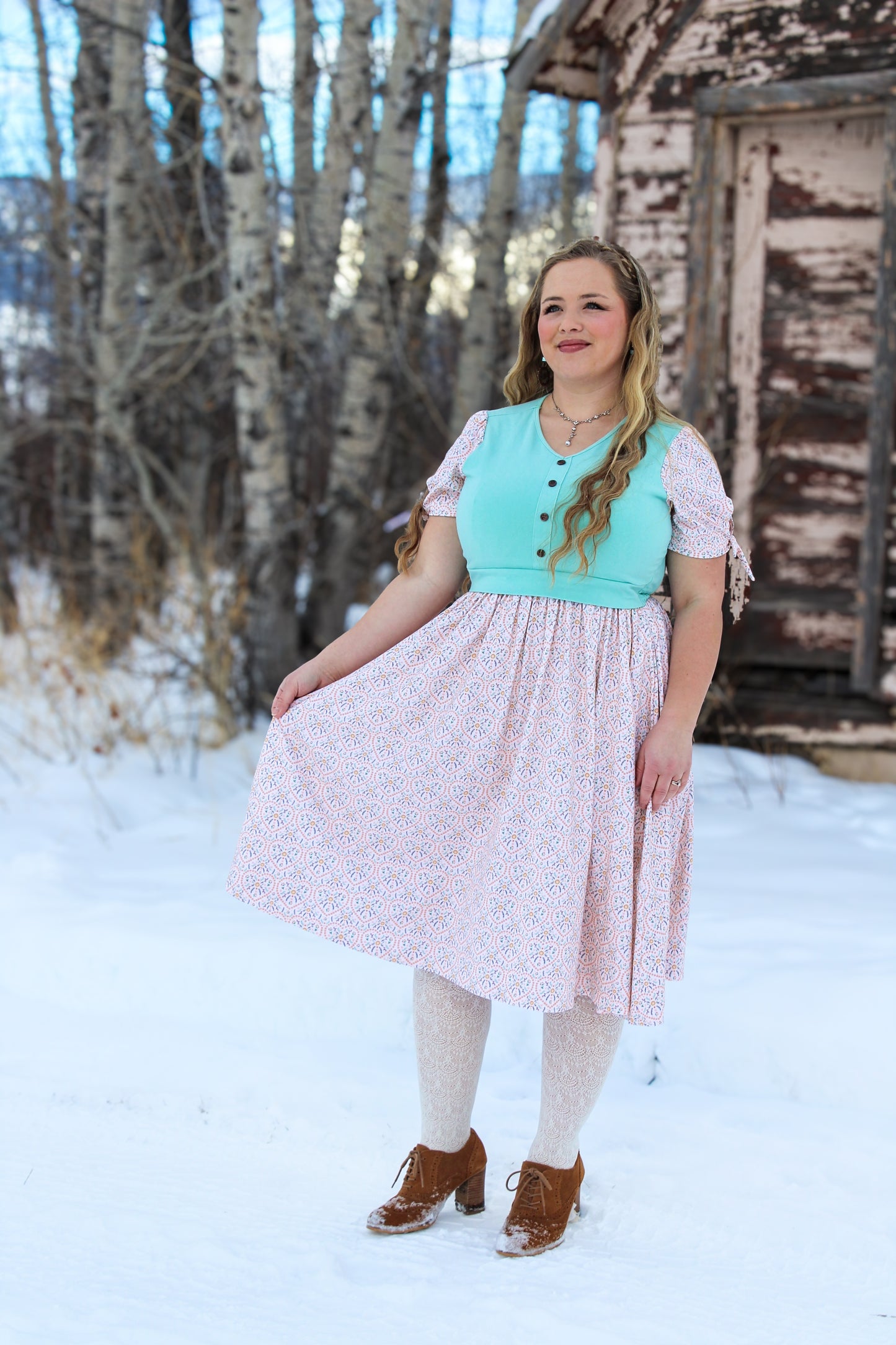 A woman wearing a vintage style modest nursing dress.