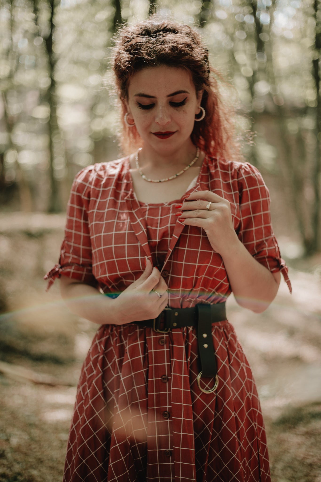Woman in modest nursing red plaid dress forest