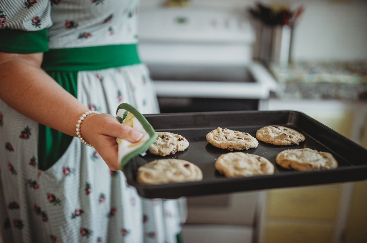 woman wearing a green and white striped modest nursing dress