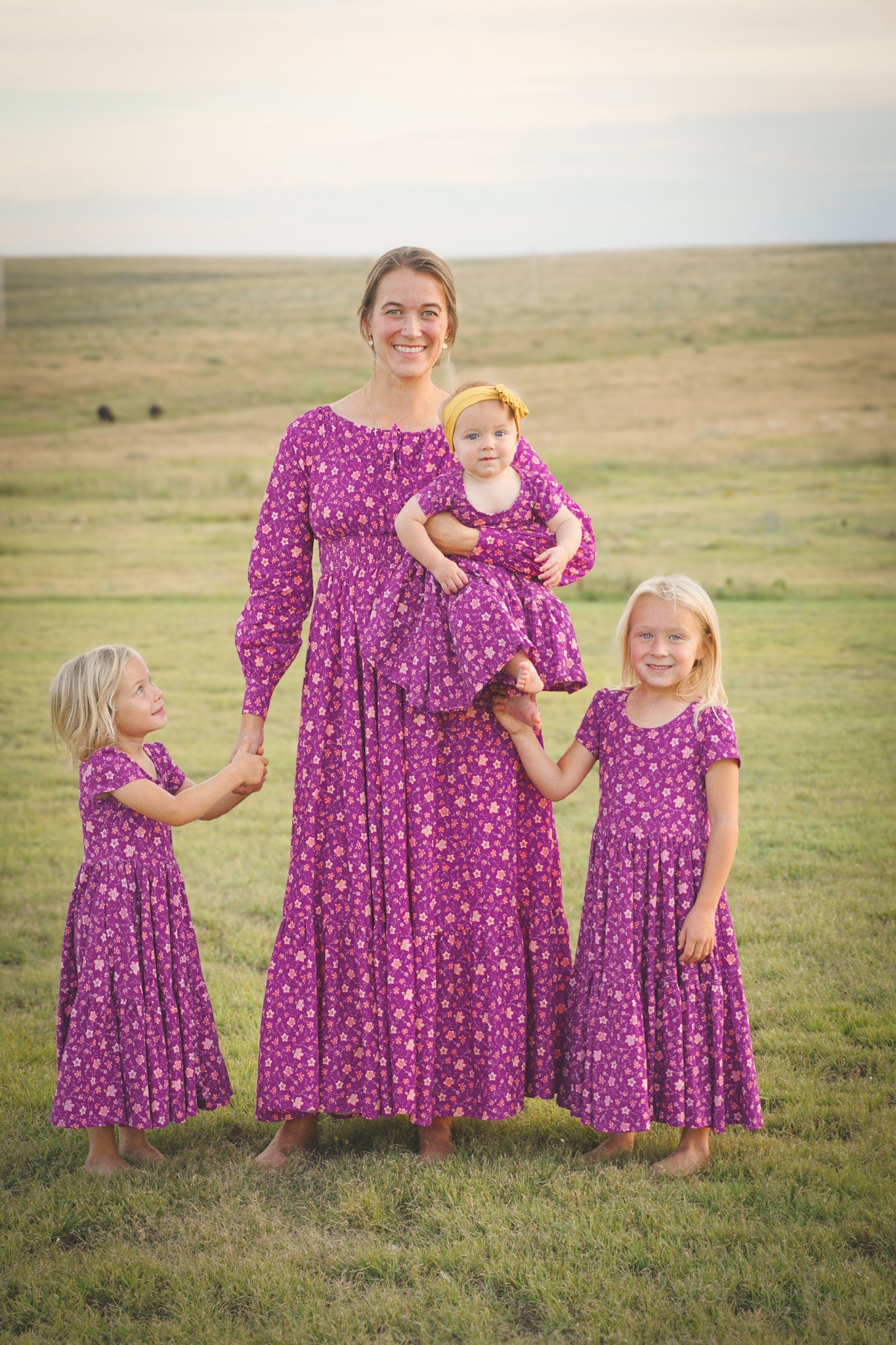 Woman in modest nursing dress with three daughters in matching dresses