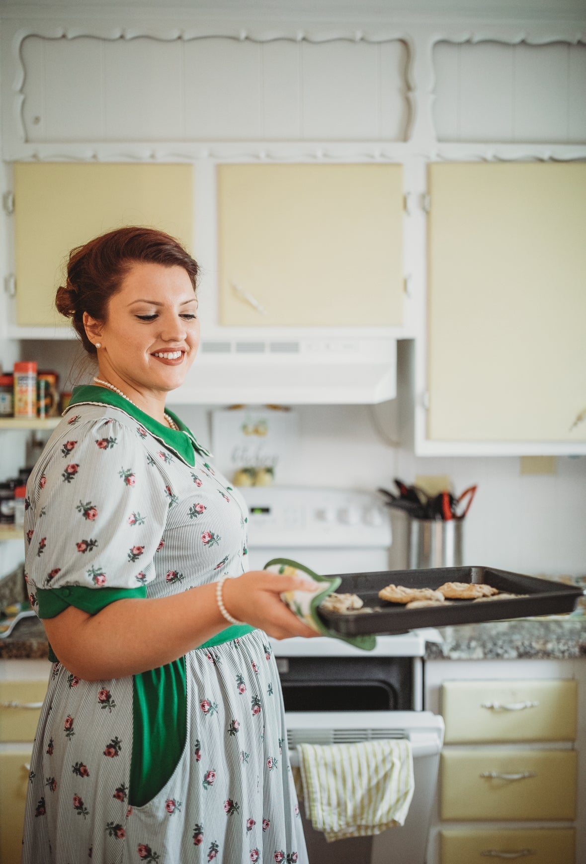 woman wearing a green and white striped modest nursing dress