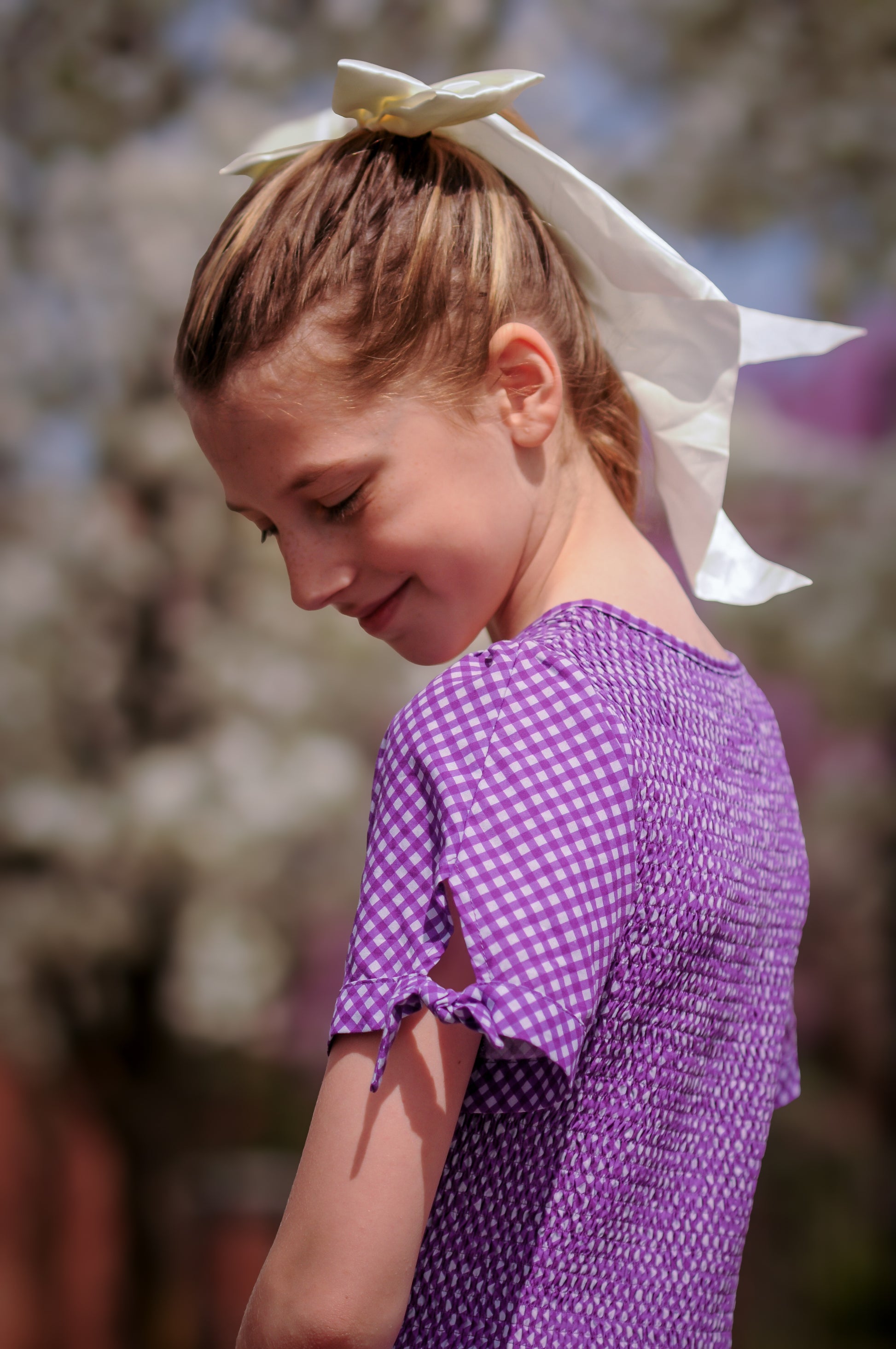 Young girl wearing a modest purple dress